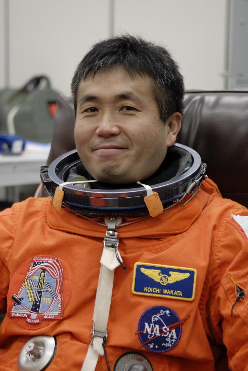 CAPE CANAVERAL, Fla. –   At NASA's Kennedy Space Center in Florida, STS-119 Mission Specialist Koichi Wakata is donning his launch-and-entry suit before heading to Launch Pad 39A for a simulated launch countdown. The astronauts are at Kennedy to prepare for launch through Terminal Countdown Demonstration Test activities. The TCDT includes equipment familiarization and emergency egress training. The crew is targeted to launch on the STS-119 mission Feb. 12 on space shuttle Discovery. During the 14-day mission, the crew will install the S6 truss segment and solar arrays to the starboard side of the International Space Station, completing the station's truss, or backbone.    Photo credit: NASA/Kim Shiflett