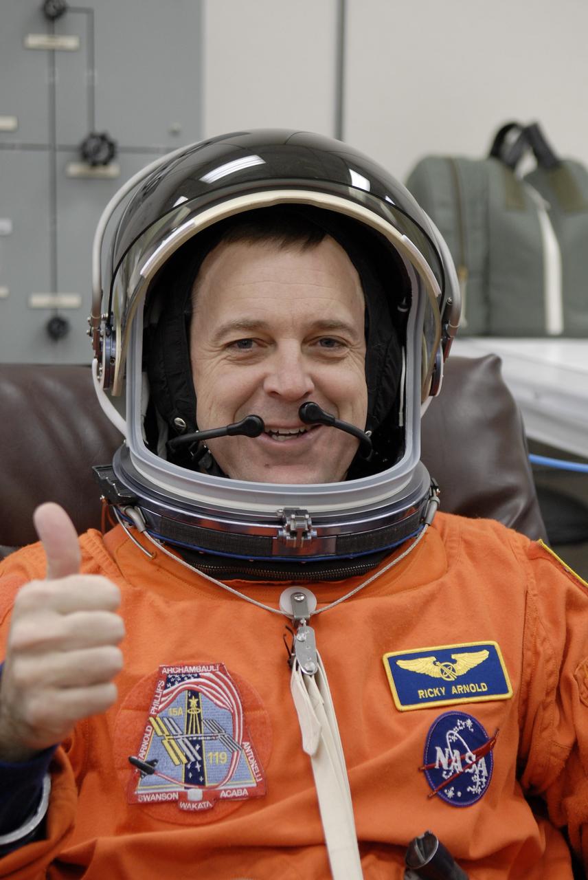 CAPE CANAVERAL, Fla. –   At NASA's Kennedy Space Center in Florida, STS-119 Mission Specialist Richard Arnold is fitted with the helmet for his launch-and-entry suit before heading to Launch Pad 39A for a simulated launch countdown. The astronauts are at Kennedy to prepare for launch through Terminal Countdown Demonstration Test activities. The TCDT includes equipment familiarization and emergency egress training. The crew is targeted to launch on the STS-119 mission Feb. 12 on space shuttle Discovery. During the 14-day mission, the crew will install the S6 truss segment and solar arrays to the starboard side of the International Space Station, completing the station's truss, or backbone.    Photo credit: NASA/Kim Shiflett