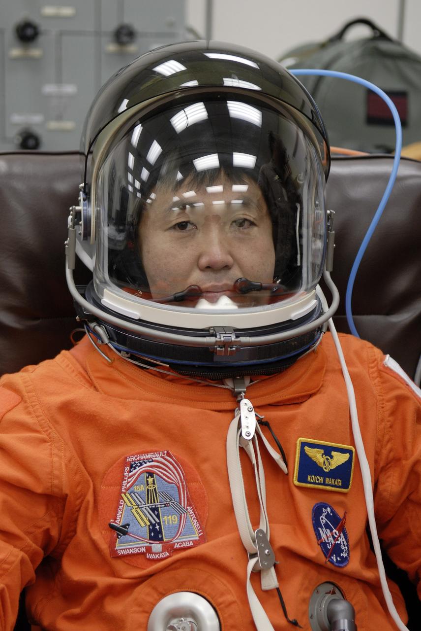 CAPE CANAVERAL, Fla. –   At NASA's Kennedy Space Center in Florida, STS-119 Mission Specialist Koichi Wakata is fitted with the helmet for his launch-and-entry suit before heading to Launch Pad 39A for a simulated launch countdown.  The astronauts are at Kennedy to prepare for launch through Terminal Countdown Demonstration Test activities. The TCDT includes equipment familiarization and emergency egress training. The crew is targeted to launch on the STS-119 mission Feb. 12 on space shuttle Discovery. During the 14-day mission, the crew will install the S6 truss segment and solar arrays to the starboard side of the International Space Station, completing the station's truss, or backbone.    Photo credit: NASA/Kim Shiflett