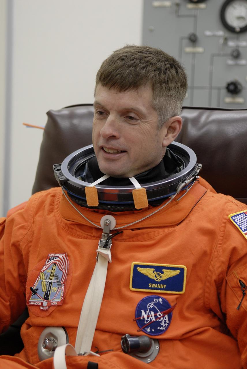 CAPE CANAVERAL, Fla. –   At NASA's Kennedy Space Center in Florida, STS-119 Mission Specialist Steve Swanson dons his launch-and-entry suit before heading to Launch Pad 39A for a simulated launch countdown. The astronauts are at Kennedy to prepare for launch through Terminal Countdown Demonstration Test activities. The TCDT includes equipment familiarization and emergency egress training. The crew is targeted to launch on the STS-119 mission Feb. 12 on space shuttle Discovery. During the 14-day mission, the crew will install the S6 truss segment and solar arrays to the starboard side of the International Space Station, completing the station's truss, or backbone.    Photo credit: NASA/Kim Shiflett