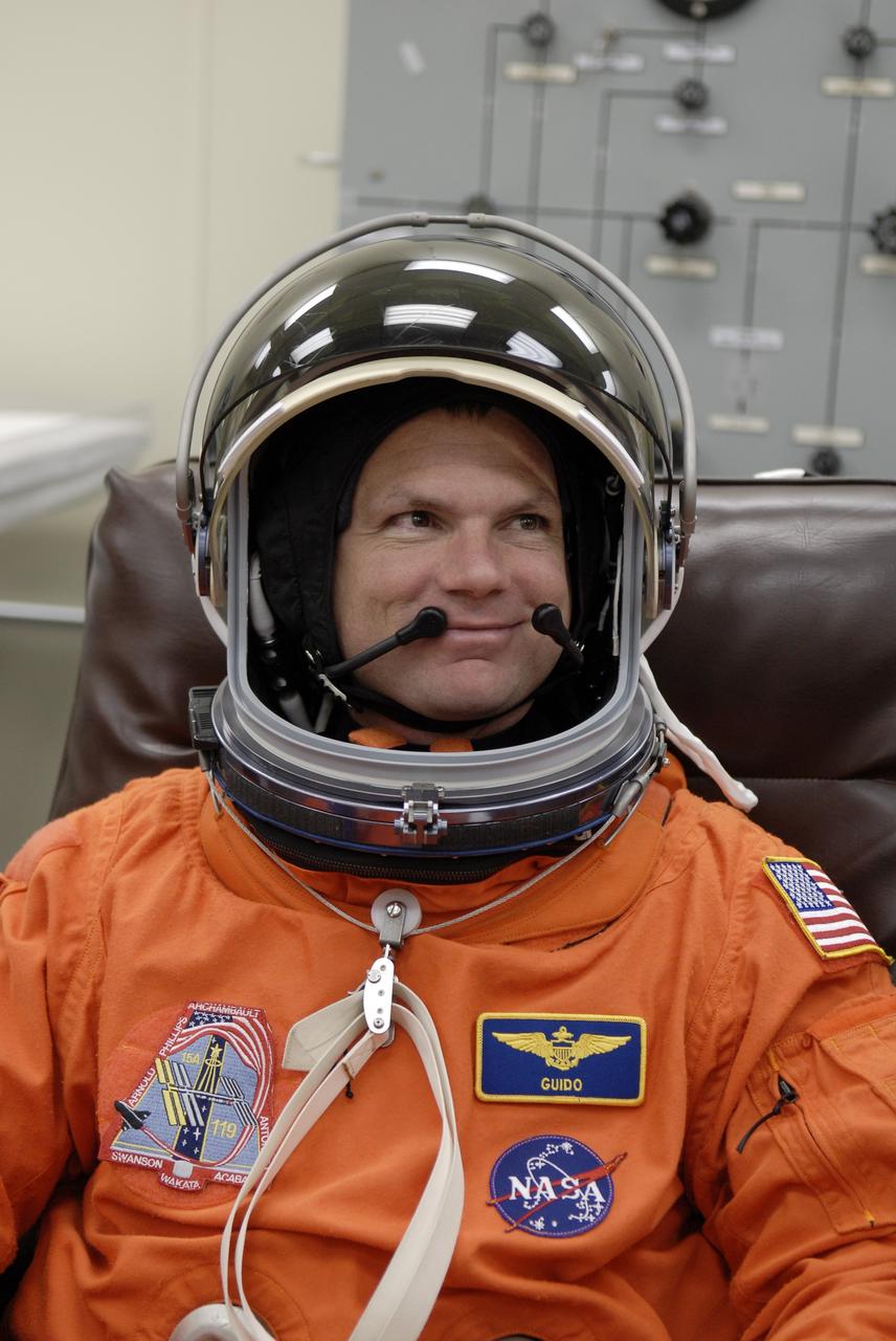 CAPE CANAVERAL, Fla. –  At NASA's Kennedy Space Center in Florida, STS-119 Pilot Tony Antonelli tries on his helmet to complete the launch-and-entry suit before heading to Launch Pad 39A for a simulated launch countdown. The astronauts are at Kennedy to prepare for launch through Terminal Countdown Demonstration Test activities. The TCDT includes equipment familiarization and emergency egress training. The crew is targeted to launch on the STS-119 mission Feb. 12 on space shuttle Discovery. During the 14-day mission, the crew will install the S6 truss segment and solar arrays to the starboard side of the International Space Station, completing the station's truss, or backbone.    Photo credit: NASA/Kim Shiflett
