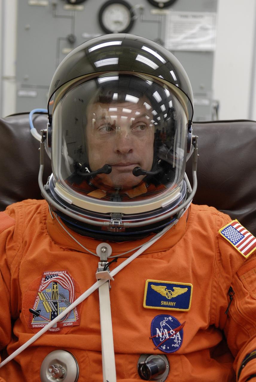 CAPE CANAVERAL, Fla. –  At NASA's Kennedy Space Center in Florida, STS-119 Mission Specialist Steve Swanson tries on his helmet to complete the launch-and-entry suit before heading to Launch Pad 39A for a simulated launch countdown. The astronauts are at Kennedy to prepare for launch through Terminal Countdown Demonstration Test activities. The TCDT includes equipment familiarization and emergency egress training. The crew is targeted to launch on the STS-119 mission Feb. 12 on space shuttle Discovery. During the 14-day mission, the crew will install the S6 truss segment and solar arrays to the starboard side of the International Space Station, completing the station's truss, or backbone.    Photo credit: NASA/Kim Shiflett