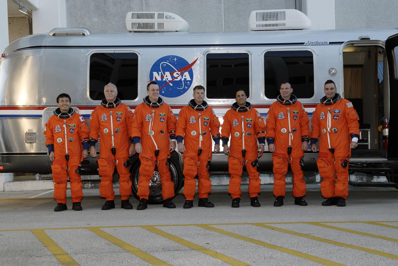 CAPE CANAVERAL, Fla. – At NASA's Kennedy Space Center in Florida, the STS-119 crew members pause in front of the Astrovan before boarding it to head to Launch Pad 39A for a simulated launch countdown. From left are Mission Specialists Koichi Wakata, John Phillips, Richard Arnold, Steve Swanson and Joseph Acaba, Pilot Tony Antonelli and Commander Lee Archambault. The astronauts are at Kennedy to prepare for launch through Terminal Countdown Demonstration Test activities. The TCDT includes equipment familiarization and emergency egress training. The crew is targeted to launch on the STS-119 mission Feb. 12 on space shuttle Discovery. During the 14-day mission, the crew will install the S6 truss segment and solar arrays to the starboard side of the International Space Station, completing the station's truss, or backbone. Photo credit: NASA/Kim Shiflett