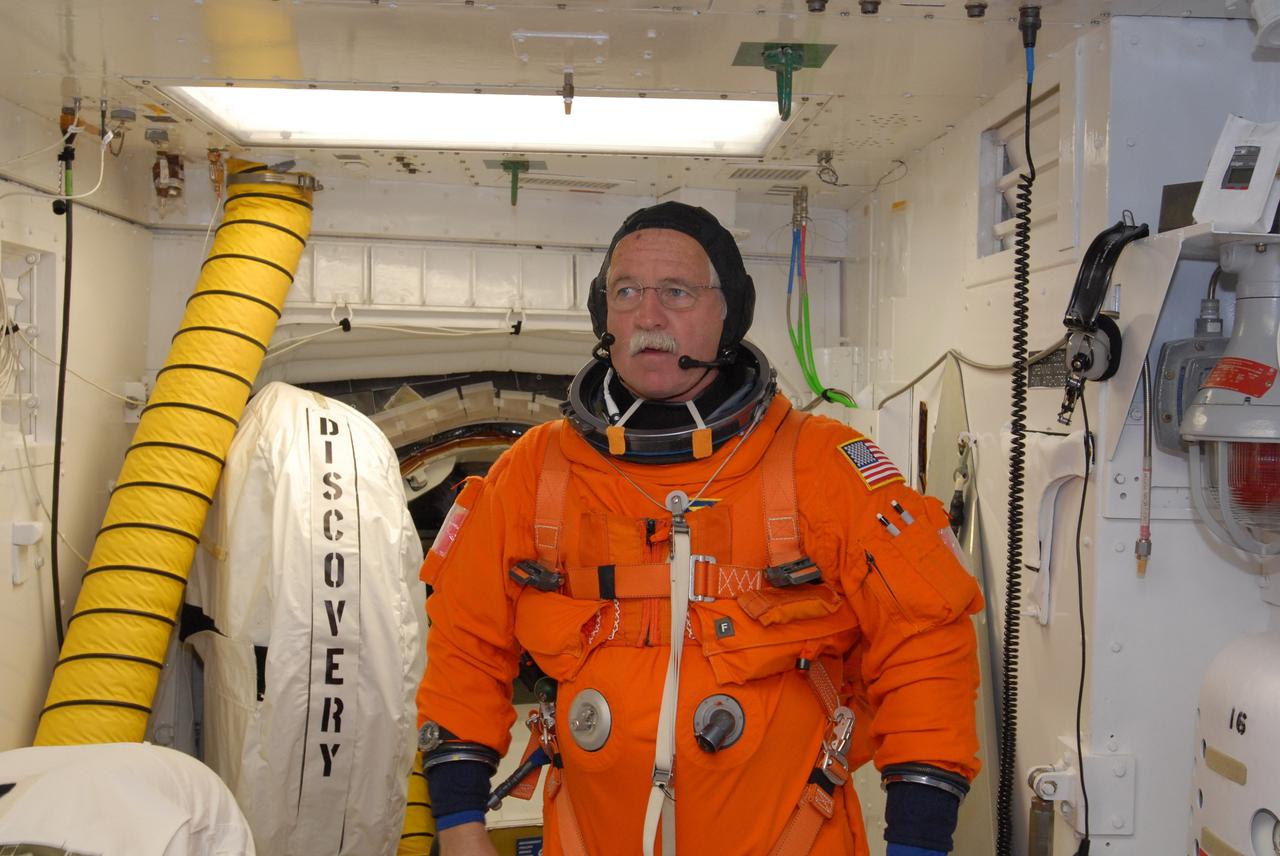 CAPE CANAVERAL, Fla. –   In the White Room on Launch Pad 39A at NASA's Kennedy Space Center in Florida, STS-119 Mission Specialist John Phillips has donned the harness over his launch-and-entry suit. The White Room provides access into space shuttle Discovery.  Phillips and other crew members will conduct a simulated launch countdown as part of the prelaunch preparation known as Terminal Countdown Demonstration Test. The TCDT also includes equipment familiarization and emergency egress training. Discovery is targeted to launch on the STS-119 mission Feb. 12. During the 14-day mission, the crew will install the S6 truss segment and solar arrays to the starboard side of the International Space Station, completing the station's truss, or backbone. Photo credit: NASA/Jim Grossmann