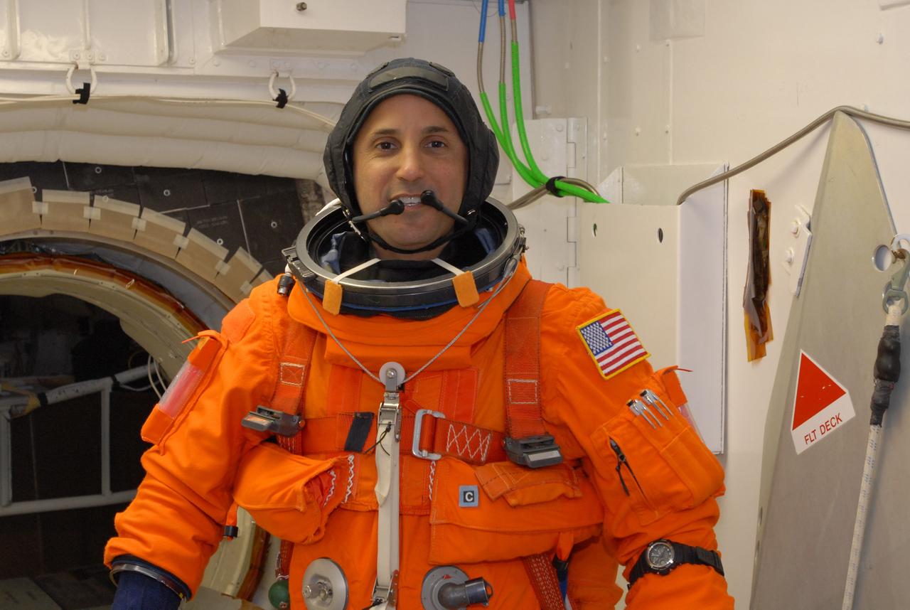 CAPE CANAVERAL, Fla. –  In the White Room on Launch Pad 39A at NASA's Kennedy Space Center in Florida, STS-119 Mission Specialist Joseph Acaba is ready to enter space shuttle Discovery, behind him. The White Room provides access into Discovery.  Acaba and other crew members will conduct a simulated launch countdown as part of the prelaunch preparation known as Terminal Countdown Demonstration Test. The TCDT also includes equipment familiarization and emergency egress training. Discovery is targeted to launch on the STS-119 mission Feb. 12. During the 14-day mission, the crew will install the S6 truss segment and solar arrays to the starboard side of the International Space Station, completing the station's truss, or backbone. Photo credit: NASA/Jim Grossmann