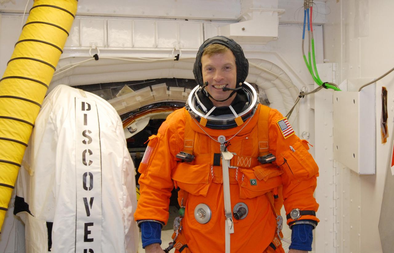 CAPE CANAVERAL, Fla. –  In the White Room on Launch Pad 39A at NASA's Kennedy Space Center in Florida, STS-119 Mission Specialist Steve Swanson is ready to enter space shuttle Discovery, behind him. The White Room provides access into Discovery.  Swanson and other crew members will conduct a simulated launch countdown as part of the prelaunch preparation known as Terminal Countdown Demonstration Test.  The TCDT also includes equipment familiarization and emergency egress training. Discovery is targeted to launch on the STS-119 mission Feb. 12. During the 14-day mission, the crew will install the S6 truss segment and solar arrays to the starboard side of the International Space Station, completing the station's truss, or backbone. Photo credit: NASA/Jim Grossmann