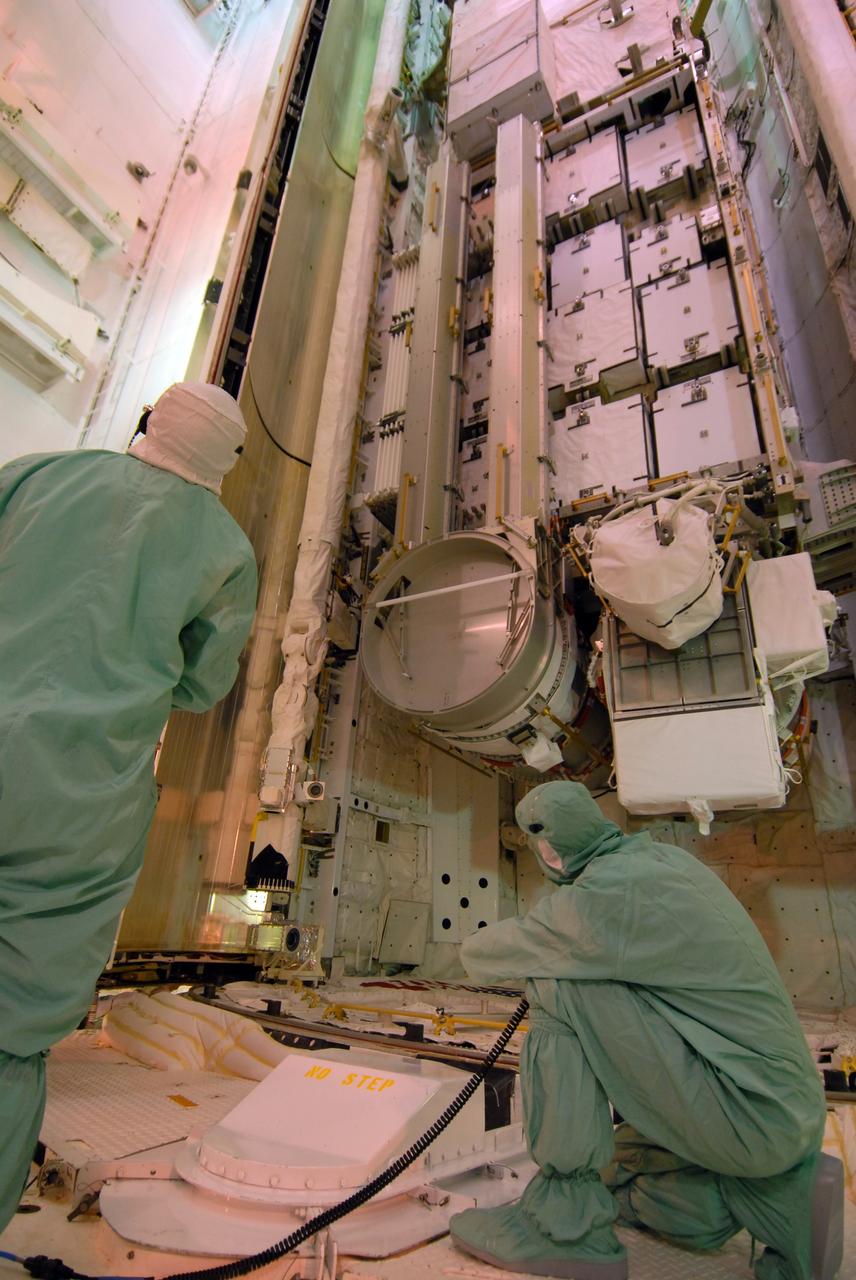 CAPE CANAVERAL, Fla. –  On Launch Pad 39A at NASA's Kennedy Space Center in Florida,  workers check the movement of space shuttle Discovery's payload bay doors as they close around the cargo.  The cargo consists of the integrated truss structure S6 and solar arrays for the STS-119 mission to the International Space Station.  During Discovery's 14-day mission, the shuttle's seven astronauts will install the S6 truss to the starboard side of the space station, completing the station's truss, or backbone. Launch of Discovery on the STS-119 mission is targeted for Feb. 12.  Photo credit: NASA/Dimitri Gerondidakis