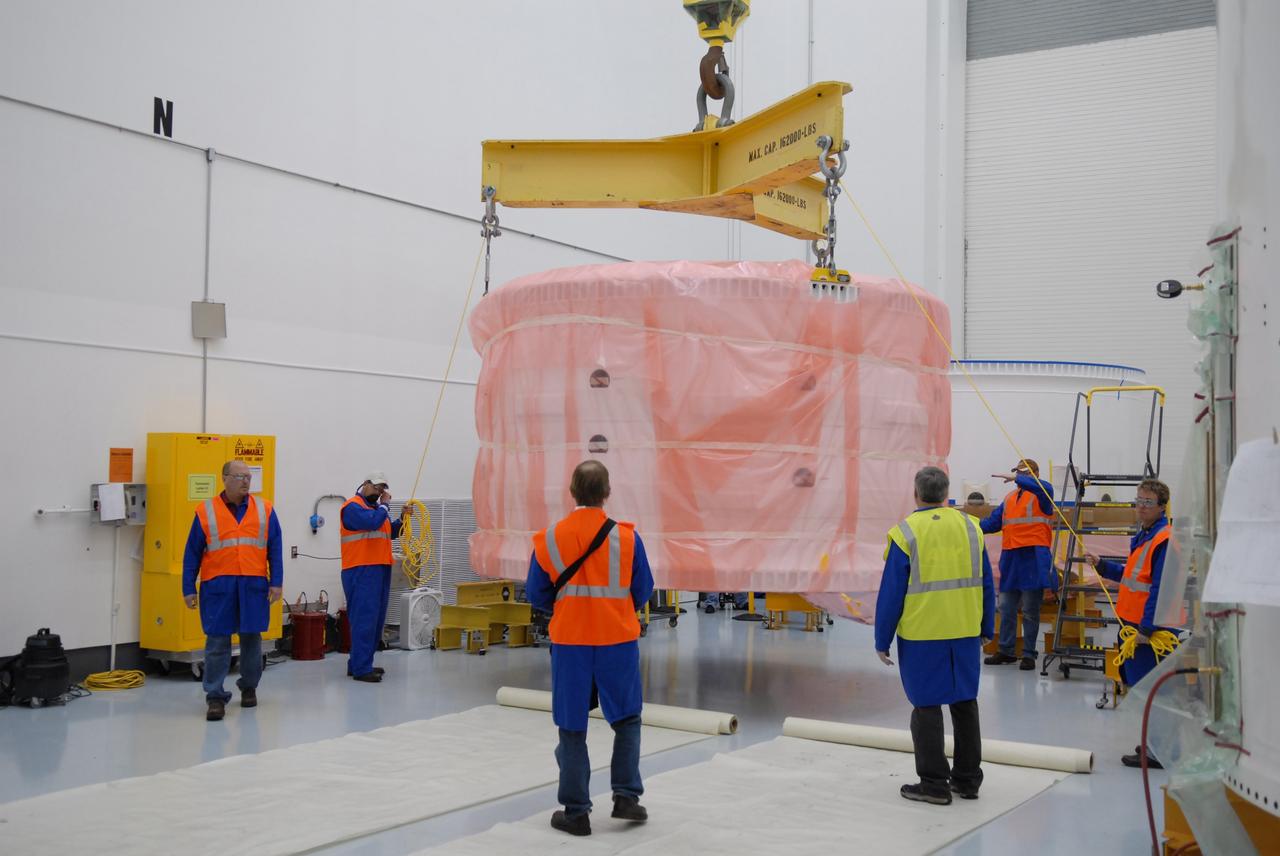 CAPE CANAVERAL, Fla. – At Astrotech in Titusville, Fla., the Ares I-X forward skirt, wrapped in a protective cover, is lifted by a crane for a move to a transporter. The segment will be transferred to the Assembly and Refurbishment Facility, or ARF, at NASA's Kennedy Space Center in Florida. The forward skirt is the initial piece of first-stage hardware in preparation for the July 2009 test flight of the agency's next-generation spacecraft and launch vehicle system. Built entirely of armored steel, the 14,000-pound segment is seven feet tall and 12-1/4 feet wide. United Space Alliance, under a subcontract to ATK, will complete the integration and assembly of the forward skirt components in the ARF. It will then be moved to the Vehicle Assembly Building high bay 3 for stacking operations. Photo credit: NASA/Tim Jacobs