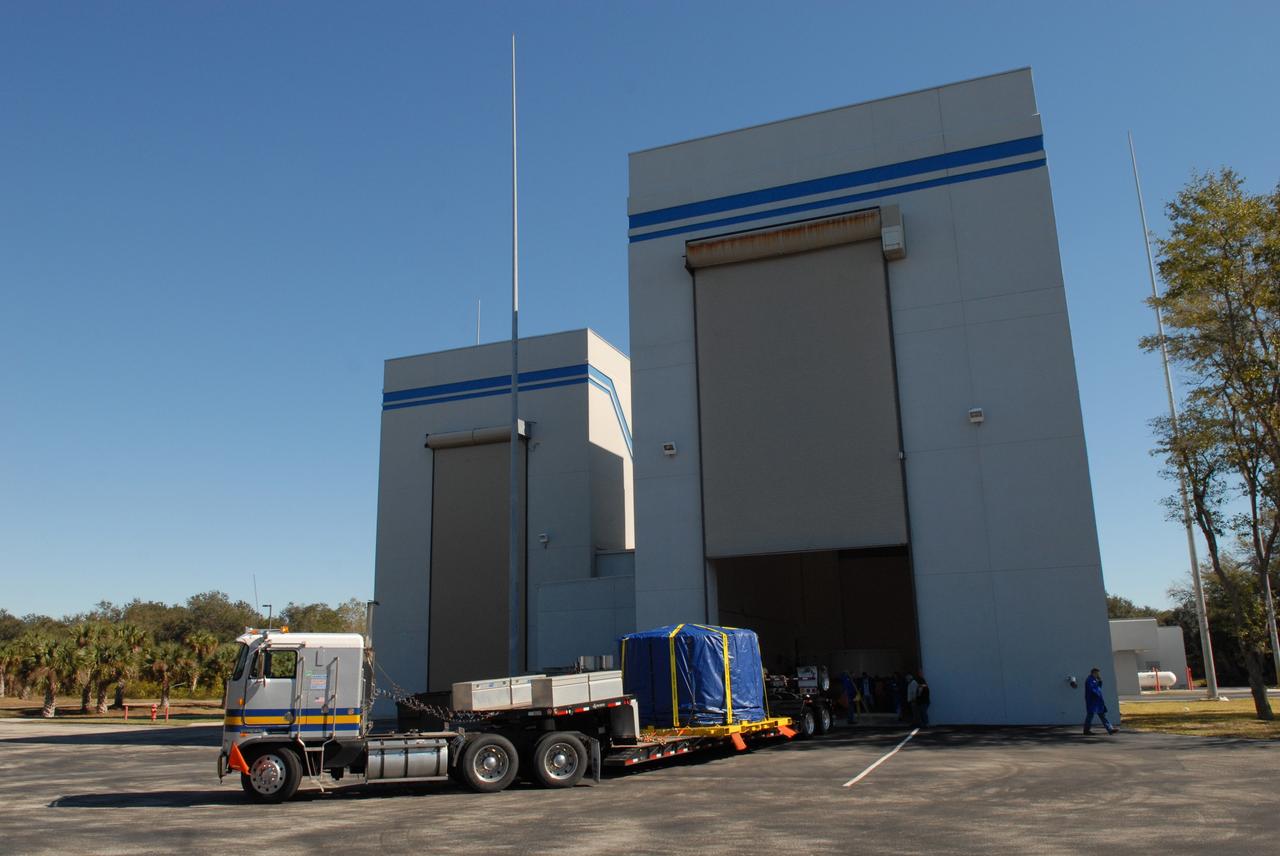 CAPE CANAVERAL, Fla. – Wrapped and strapped, the Ares I-X forward skirt is transported away from Astrotech in Titusville, Fla., heading for the Assembly and Refurbishment Facility, or ARF, at NASA's Kennedy Space Center in Florida. The forward skirt is the initial piece of first-stage hardware in preparation for the July 2009 test flight of the agency's next-generation spacecraft and launch vehicle system. Built entirely of armored steel, the 14,000-pound segment is seven feet tall and 12-1/4 feet wide. United Space Alliance, under a subcontract to ATK, will complete the integration and assembly of the forward skirt components in the ARF. It will then be moved to the Vehicle Assembly Building high bay 3 for stacking operations. Photo credit: NASA/Tim Jacobs