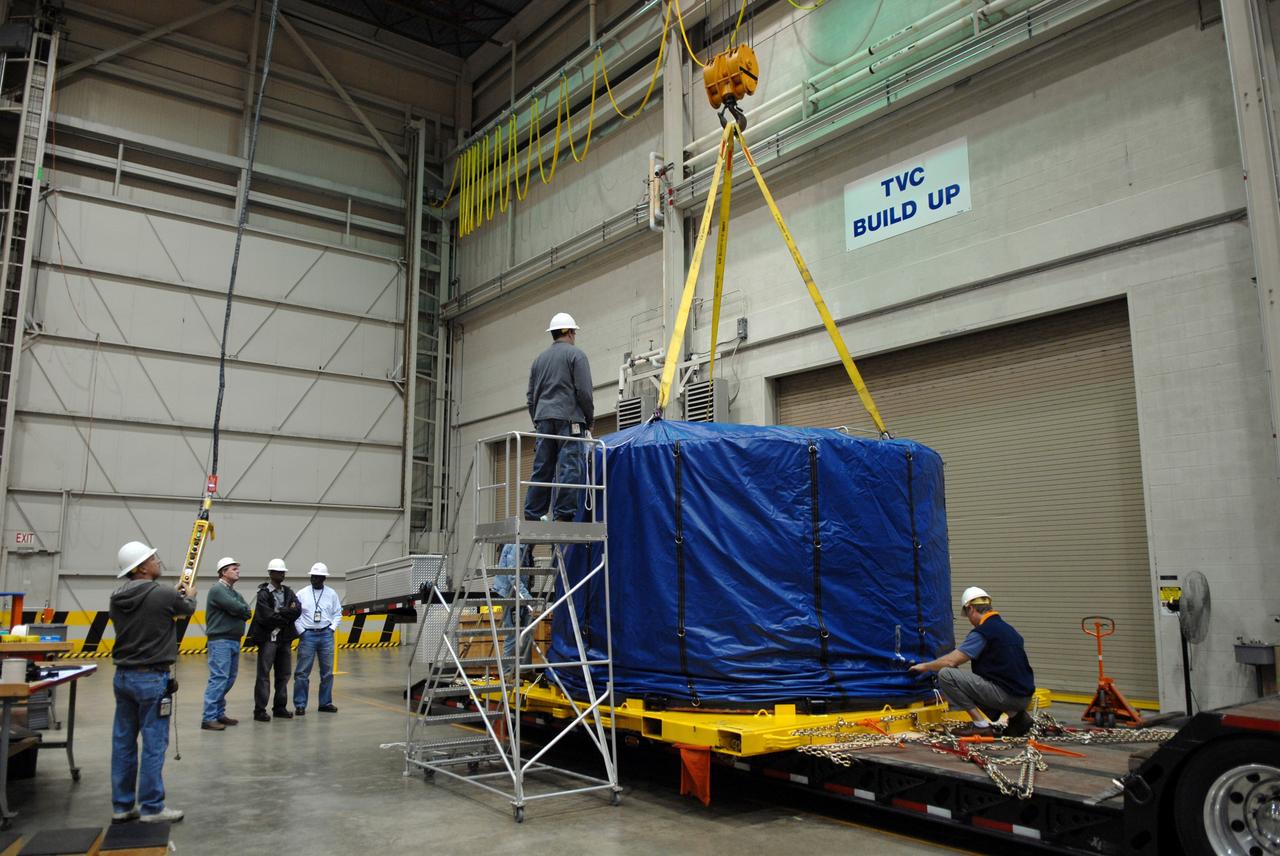 CAPE CANAVERAL, Fla. – Inside the Assembly and Refurbishment Facility, or ARF, at NASA's Kennedy Space Center in Florida, the padding is being removed from around the Ares I-X forward skirt. It was transferred from the Astrotech facility in Titusville, Fla. The forward skirt is the initial piece of first-stage hardware in preparation for the July 2009 test flight of the agency's next-generation spacecraft and launch vehicle system. Built entirely of armored steel, the 14,000-pound segment is seven feet tall and 12-1/4 feet wide. United Space Alliance, under a subcontract to ATK, will complete the integration and assembly of the forward skirt components in the ARF. It will then be moved to the Vehicle Assembly Building high bay 3 for stacking operations. Photo credit: NASA/Tim Jacobs