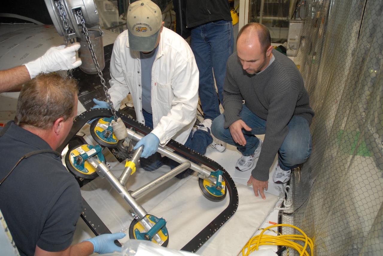 CAPE CANAVERAL, Fla. – In Orbiter Processing Facility bay 2 at NASA's Kennedy Space Center in Florida, workers attach a tool to lift the replacement window for space shuttle Endeavour. Endeavour is the designated launch vehicle for the STS-127 mission. The Japanese Experiment Module's Experiment Logistics Module-Exposed Section, or ELM-ES, is part of the payload on the mission, targeted for launch on May 15. Photo credit: NASA/Tim Jacobs