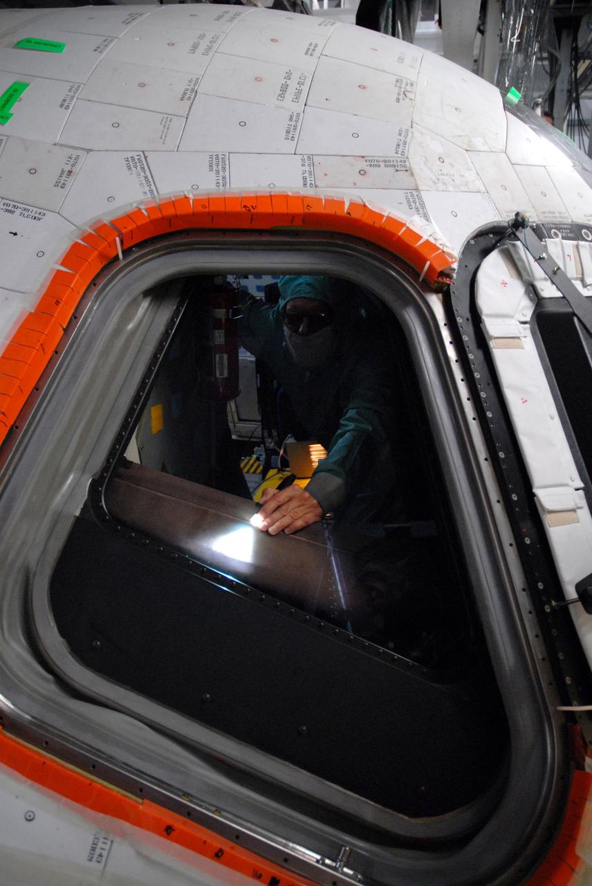 CAPE CANAVERAL, Fla. – In Orbiter Processing Facility bay 2 at NASA's Kennedy Space Center in Florida, a worker inside space shuttle Endeavour checks the area where the new window will be installed. Endeavour is the designated launch vehicle for the STS-127 mission. The Japanese Experiment Module's Experiment Logistics Module-Exposed Section, or ELM-ES, is part of the payload on the mission, targeted for launch on May 15. Photo credit: NASA/Tim Jacobs