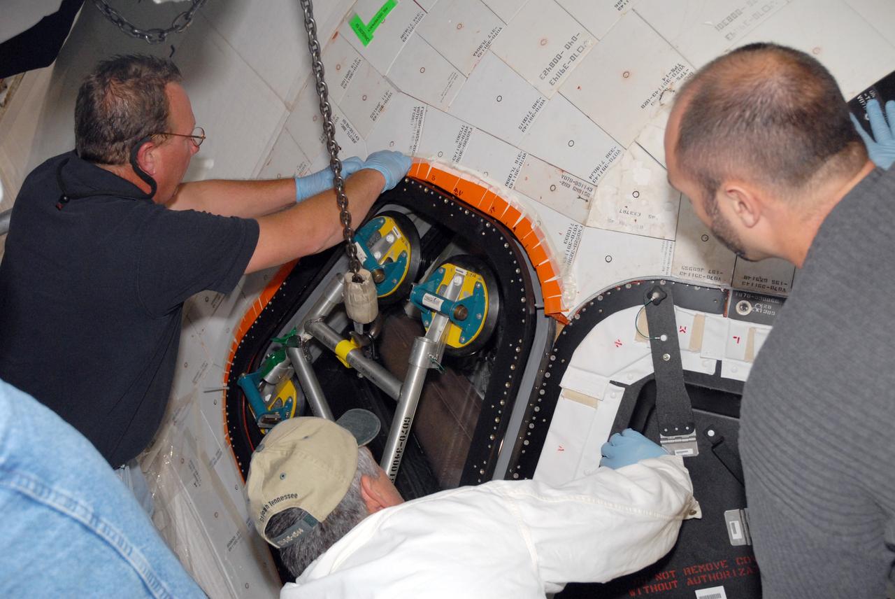 CAPE CANAVERAL, Fla. –  In Orbiter Processing Facility bay 2 at NASA's Kennedy Space Center in Florida, workers put the new window six into place on space shuttle Endeavour.  Endeavour is the designated launch vehicle for the STS-127 mission.  The Japanese Experiment Module's Experiment Logistics Module-Exposed Section, or ELM-ES, is part of the payload on the mission, targeted for launch on May 15.  Photo credit: NASA/Tim Jacobs