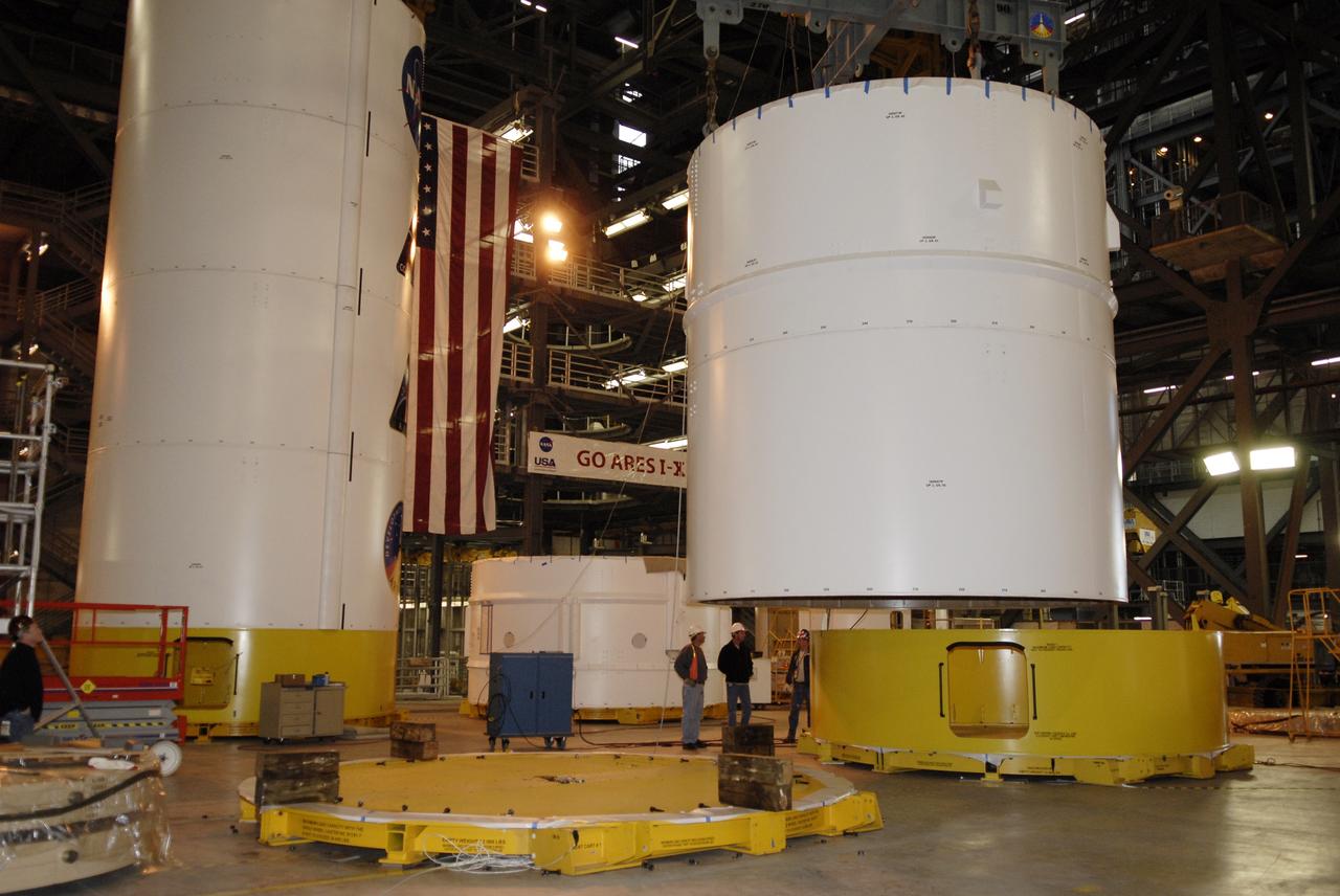 CAPE CANAVERAL, Fla. – In high bay 4 of the Vehicle Assembly Building at NASA's Kennedy Space Center in Florida, an overhead crane lifts segments 6 and 7 of the Ares I-X rocket. The segments are being moved onto a stand on the floor. Ares I-X is the test vehicle for the Ares I, which is part of the Constellation Program to return men to the moon and beyond. Ares I is the essential core of a safe, reliable, cost-effective space transportation system that eventually will carry crewed missions back to the moon, on to Mars and out into the solar system. Ares I may also use its 25-ton payload capacity to deliver resources and supplies to the International Space Station, or to "park" payloads in orbit for retrieval by other spacecraft bound for the moon or other destinations. The Ares I-X is targeted for launch in July 2009. Photo credit: NASA/Kim Shiflett