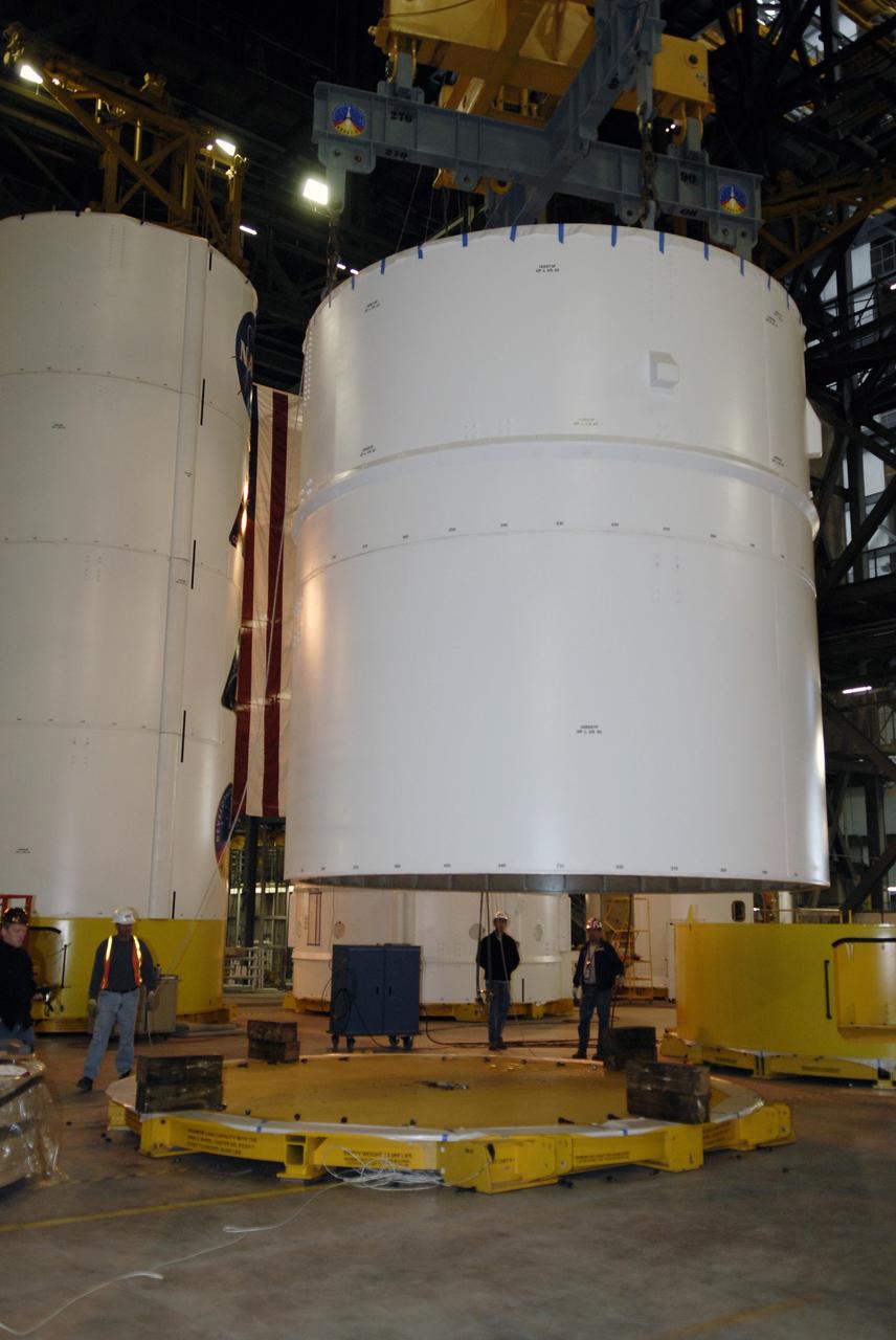 CAPE CANAVERAL, Fla. – In high bay 4 of the Vehicle Assembly Building at NASA's Kennedy Space Center in Florida, the Ares I-X segments 6 and 7 are moved toward a stand. Ares I-X is the test vehicle for the Ares I, which is part of the Constellation Program to return men to the moon and beyond. Ares I is the essential core of a safe, reliable, cost-effective space transportation system that eventually will carry crewed missions back to the moon, on to Mars and out into the solar system. Ares I may also use its 25-ton payload capacity to deliver resources and supplies to the International Space Station, or to "park" payloads in orbit for retrieval by other spacecraft bound for the moon or other destinations. The Ares I-X is targeted for launch in July 2009. Photo credit: NASA/Kim Shiflett