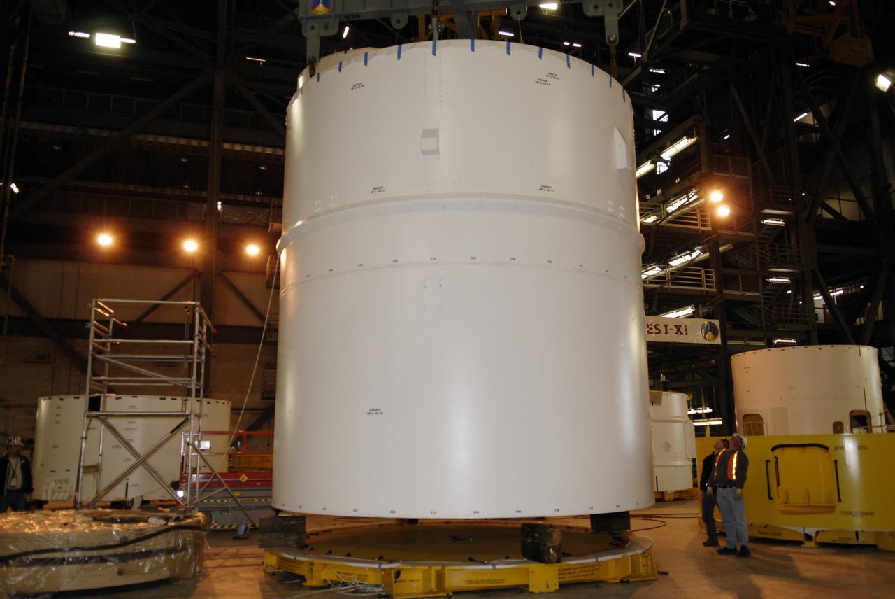 CAPE CANAVERAL, Fla. – In high bay 4 of the Vehicle Assembly Building at NASA's Kennedy Space Center in Florida, the Ares I-X segments 6 and 7 are lowered onto a stand. Ares I-X is the test vehicle for the Ares I, which is part of the Constellation Program to return men to the moon and beyond. Ares I is the essential core of a safe, reliable, cost-effective space transportation system that eventually will carry crewed missions back to the moon, on to Mars and out into the solar system. Ares I may also use its 25-ton payload capacity to deliver resources and supplies to the International Space Station, or to "park" payloads in orbit for retrieval by other spacecraft bound for the moon or other destinations. The Ares I-X is targeted for launch in July 2009. Photo credit: NASA/Kim Shiflett