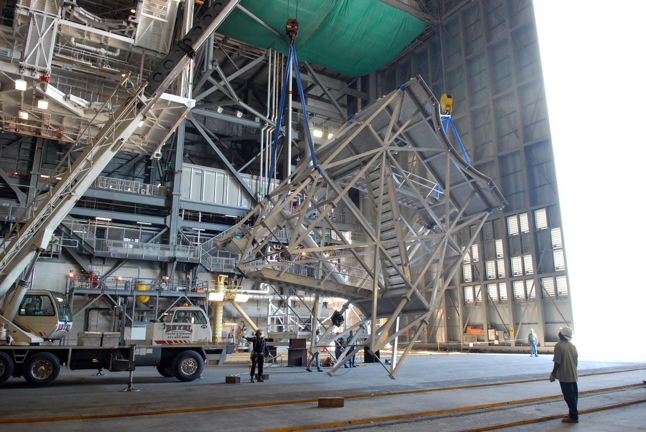 CAPE CANAVERAL, Fla. –   In the Vehicle Assembly Building at NASA's Kennedy Space Center in Florida, a new platform is lifted to install on the 16th level in high bay 3. The refurbishment of the facility is for the Constellation Program's Ares vehicles. The Ares I and Ares V rockets will be 325 feet and 360 feet tall, respectively, considerably taller than the space shuttle atop its mobile launcher platform.   Photo credit: NASA/Jack Pfaller