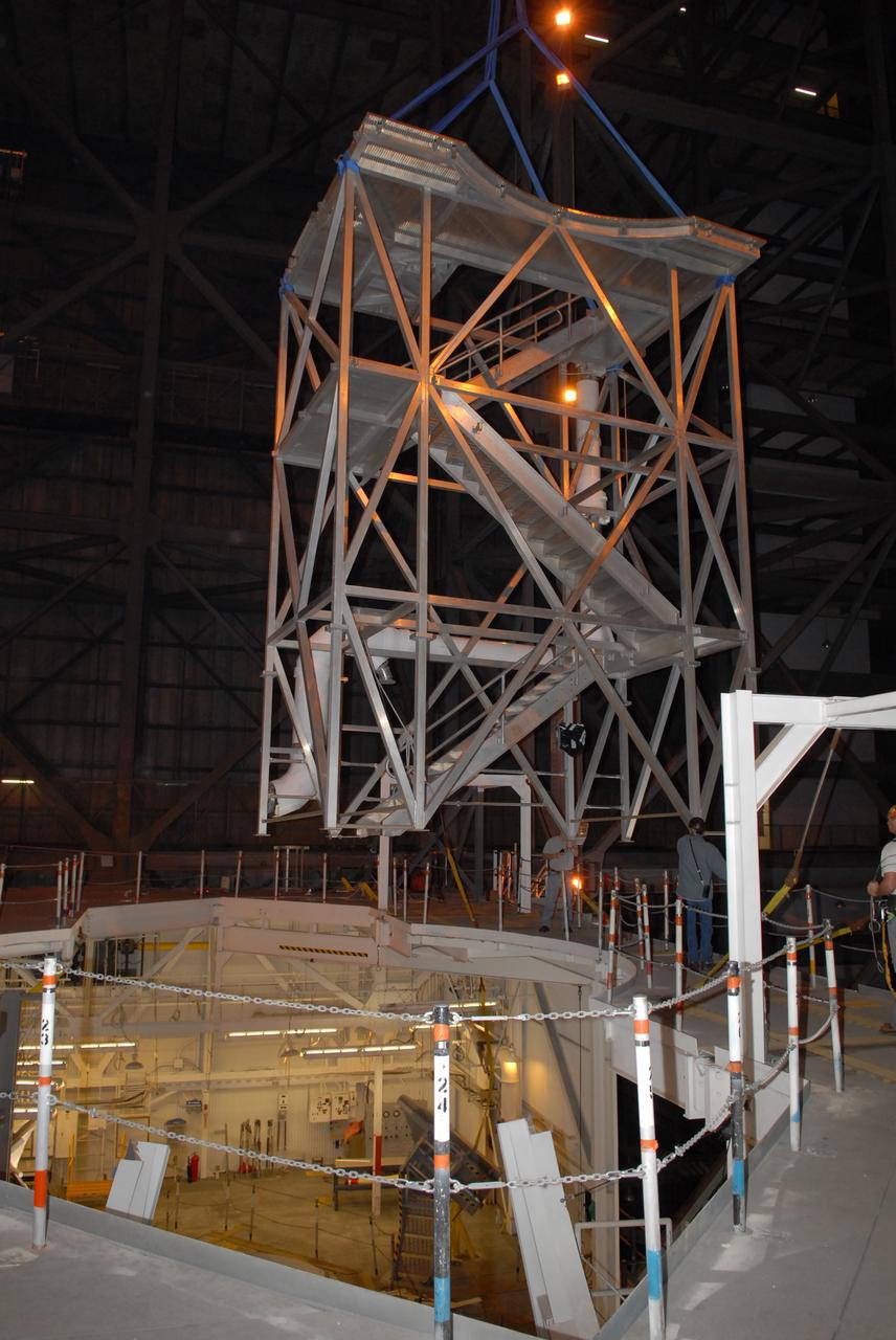 CAPE CANAVERAL, Fla. –   In the Vehicle Assembly Building at NASA's Kennedy Space Center in Florida, a new platform is lifted to install on the 16th level in high bay 3. The refurbishment of the facility is for the Constellation Program's Ares vehicles. The Ares I and Ares V rockets will be 325 feet and 360 feet tall, respectively, considerably taller than the space shuttle atop its mobile launcher platform.   Photo credit: NASA/Jack Pfaller