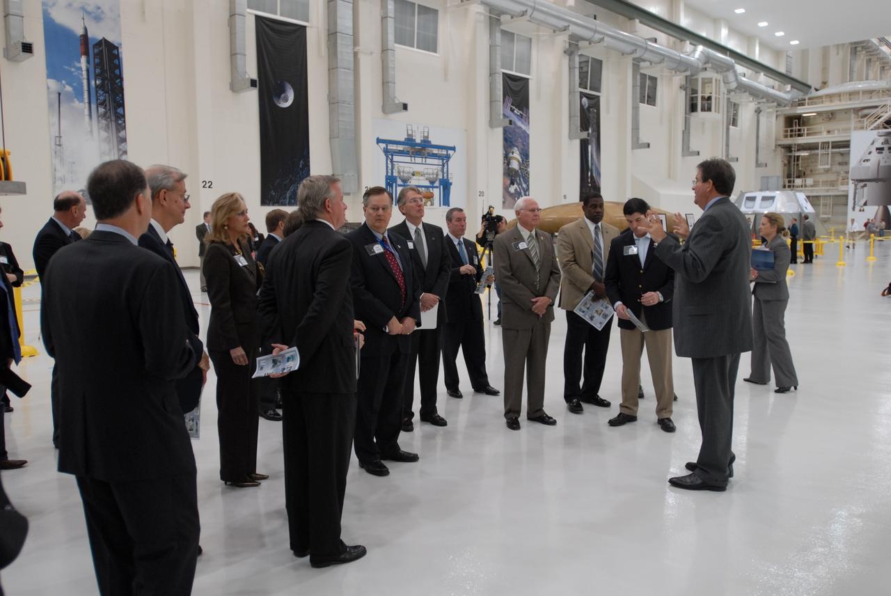 CAPE CANAVERAL, Fla. – Representatives from NASA, Lockheed Martin, Space Florida and the state of Florida participate in a ceremony at NASA's Kennedy Space Center in Florida to mark the completion of renovations on the historic Operations and Checkout Building high bay for use by the Constellation Program. At right, Richard Harris, with Lockheed Martin, describes activities that will take place in the building. Originally built to process space vehicles in the Apollo era, the building will serve as the final assembly facility for the Orion crew exploration vehicle. Orion, America's future human spaceflight vehicle, will be capable of transporting four crew members to the moon and later will support crew transfers to Mars. The Orion spacecraft also will be used to transport crew members to the International Space Station after space shuttles are retired in 2010. The first operational launch of Orion atop an Ares I rocket is planned for 2015. Photo credit: NASA/Dimitri Gerondidakis