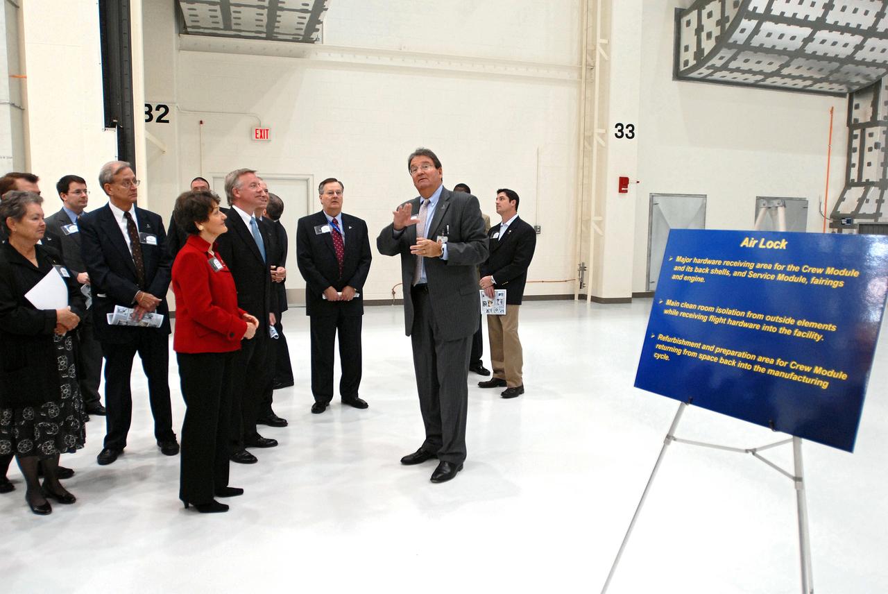 CAPE CANAVERAL, Fla. – Representatives from NASA, Lockheed Martin, Space Florida and the state of Florida participate in a ceremony at NASA's Kennedy Space Center in Florida to mark the completion of renovations on the historic Operations and Checkout Building high bay for use by the Constellation Program. At center, U.S. Rep. Suzanne Kosmas and Lt. Governor Jeff Kottcamp listen to Richard Harris, with Lockheed Martin, describe some of the hardware that will be used in the building. Originally built to process space vehicles in the Apollo era, the building will serve as the final assembly facility for the Orion crew exploration vehicle. Orion, America's future human spaceflight vehicle, will be capable of transporting four crew members to the moon and later will support crew transfers to Mars. The Orion spacecraft also will be used to transport crew members to the International Space Station after space shuttles are retired in 2010. The first operational launch of Orion atop an Ares I rocket is planned for 2015. Photo credit: NASA/Dimitri Gerondidakis