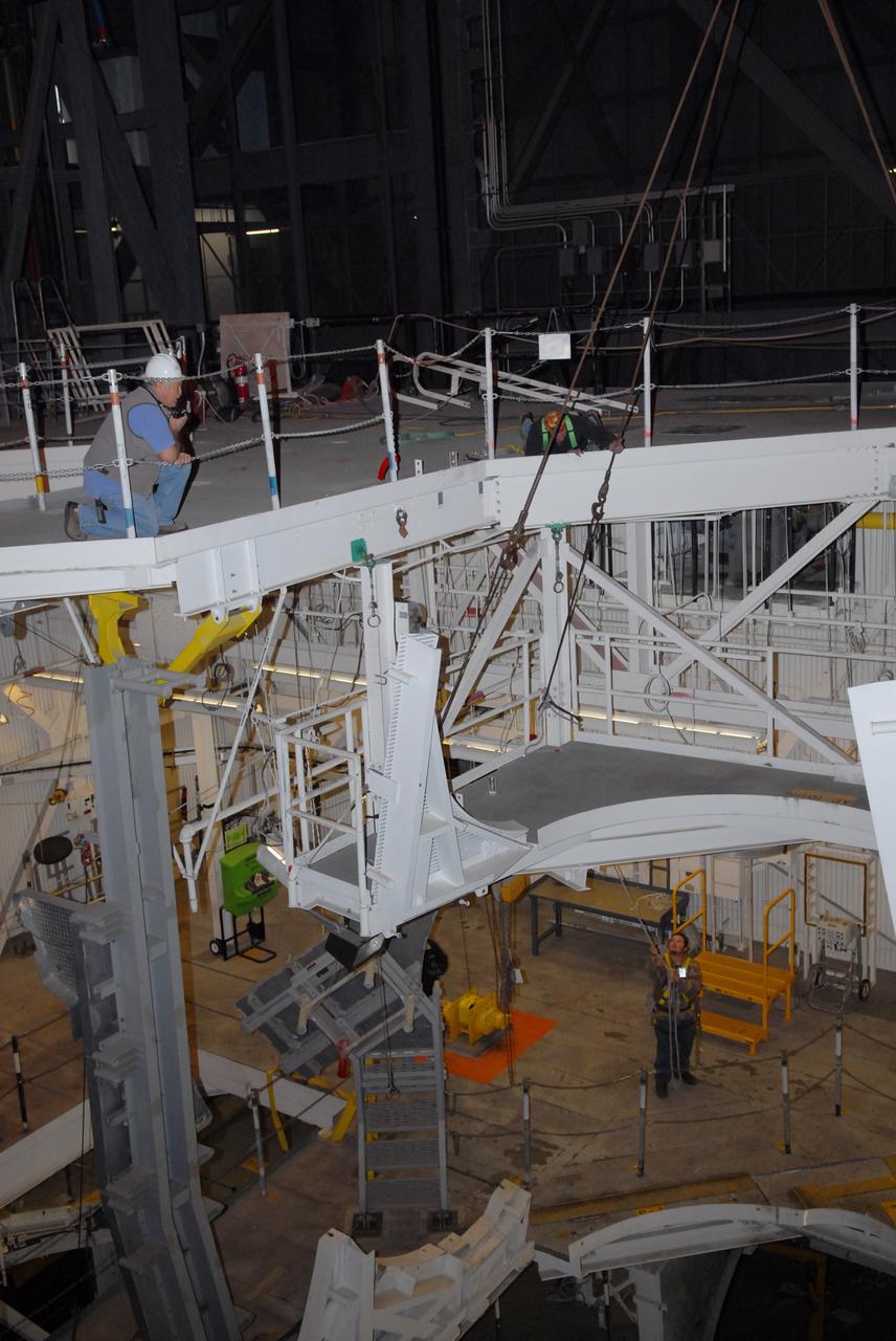 CAPE CANAVERAL, Fla. –   In the Vehicle Assembly Building at NASA's Kennedy Space Center in Florida, the platform is being lifted from an upper level in high bay 3.  Its removal is part of the refurbishment of the facility for the Constellation Program's Ares 1-X vehicle.  The Ares I and Ares V rockets will be more than 325 feet tall, considerably taller than the space shuttle atop its mobile launcher platform. Photo credit: NASA/Jack Pfaller