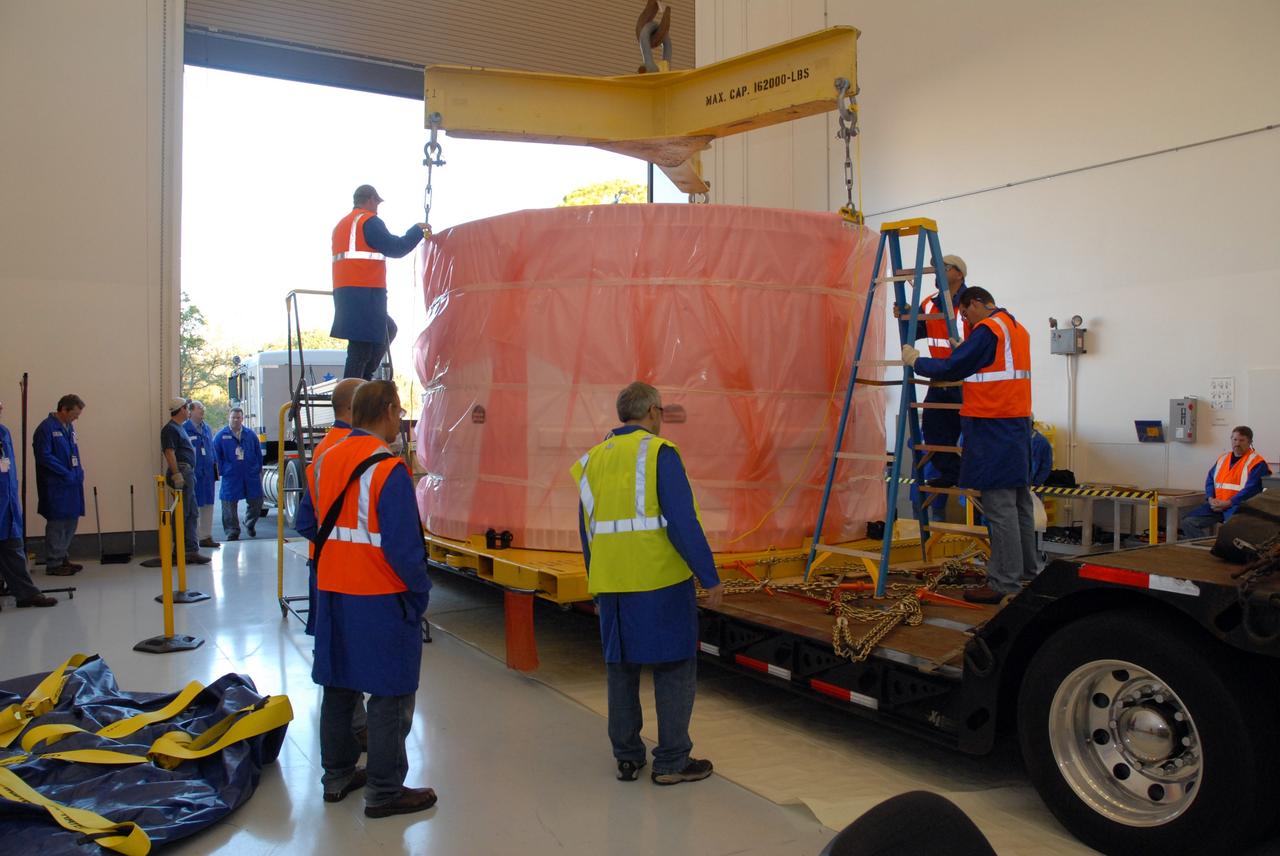 CAPE CANAVERAL, Fla. –    At Astrotech in Titusville, Fla., the bagged fifth segment simulator of the Ares I-X  is placed on a transporter.  The segment will be transferred to the Vehicle Assembly Building's extended duration orbiter lab, or EDO, at NASA's Kennedy Space Center in Florida for stacking operations.  Ares I-X is the test vehicle for the Ares I, which is part of the Constellation Program to return men to the moon and beyond.  Ares I is the essential core of a safe, reliable, cost-effective space transportation system that eventually will carry crewed missions back to the moon, on to Mars and out into the solar system. Ares I-X is targeted for launch in July 2009. Photo credit: NASA/Tim Jacobs