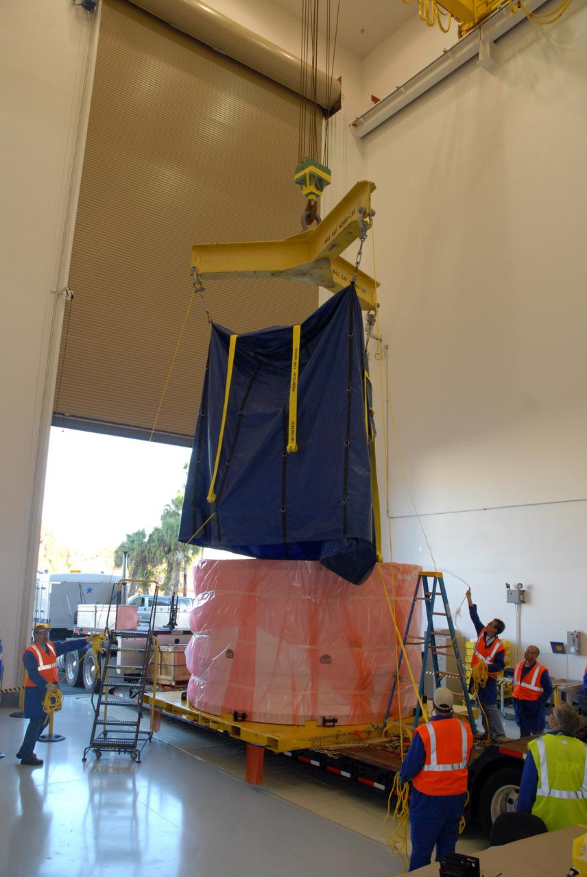 CAPE CANAVERAL, Fla. – At Astrotech in Titusville, Fla., a crane lowers a protective cover onto the bagged fifth segment simulator of the Ares I-X. The segment will be transferred to the Vehicle Assembly Building's extended duration orbiter lab, or EDO, at NASA's Kennedy Space Center in Florida for stacking operations. Ares I-X is the test vehicle for the Ares I, which is part of the Constellation Program to return men to the moon and beyond. Ares I is the essential core of a safe, reliable, cost-effective space transportation system that eventually will carry crewed missions back to the moon, on to Mars and out into the solar system. Ares I-X is targeted for launch in July 2009. Photo credit: NASA/Tim Jacobs