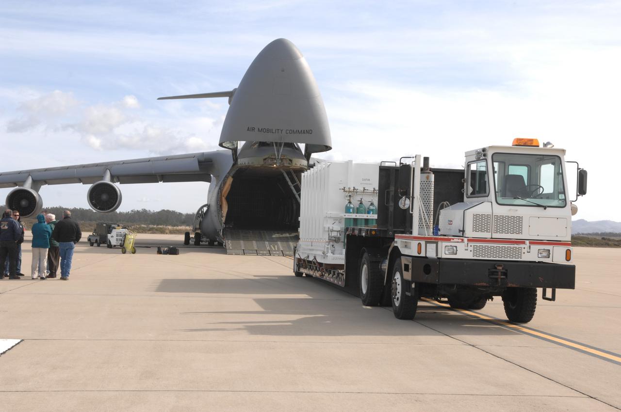 VANDENBERG AIR FORCE BASE, Calif. –   The latest polar-orbiting operational environmental weather satellite developed by NASA for the National Oceanic and Atmospheric Administration, called NOAA-N Prime, is offloaded from the C-5A military cargo aircraft at Vandenberg Air Force Base, Calif., in preparation for a Feb. 4 launch. NOAA-N Prime, built by Lockheed Martin, is similar to NOAA-N launched on May 20, 2005.
