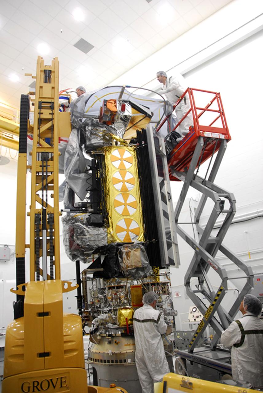 VANDENBERG AIR FORCE BASE, Calif. –  In the NASA payload processing facility at Vandenberg Air Force Base in California, workers prepare to place a protective cover around the NOAA-N Prime satellite before moving it.  NOAA-N Prime is the latest polar-orbiting operational environmental weather satellite developed by NASA for the National Oceanic and Atmospheric Administration.  It is built by Lockheed Martin and similar to NOAA-N launched on May 20, 2005. Launch of NOAA-N Prime is scheduled for Feb. 4.   Photo credit: NASA/Robert Hargreaves Jr., VAFB