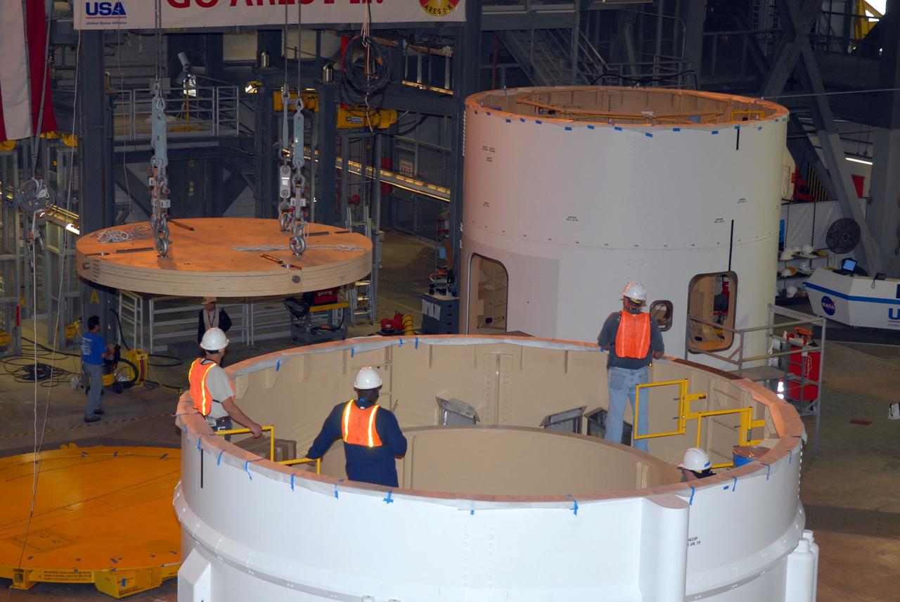 CAPE CANAVERAL, Fla. –  In Vehicle Assembly Building high bay 4, cables from an overhead crane move ballast that will be installed in segment 7 for the Ares I-X  rocket. These ballast assemblies are being installed in the upper stage segments 1 and 7 and will mimic the mass of the fuel. Their total weight is approximately 160,000 pounds.  Ares I-X  is the test vehicle for the Ares I, which is part of the Constellation Program to return men to the moon and beyond.  Ares I is the essential core of a safe, reliable, cost-effective space transportation system that eventually will carry crewed missions back to the moon, on to Mars and out into the solar system. The Ares I-X  is targeted for launch in July 2009.  Photo credit: NASA/Jack Pfaller