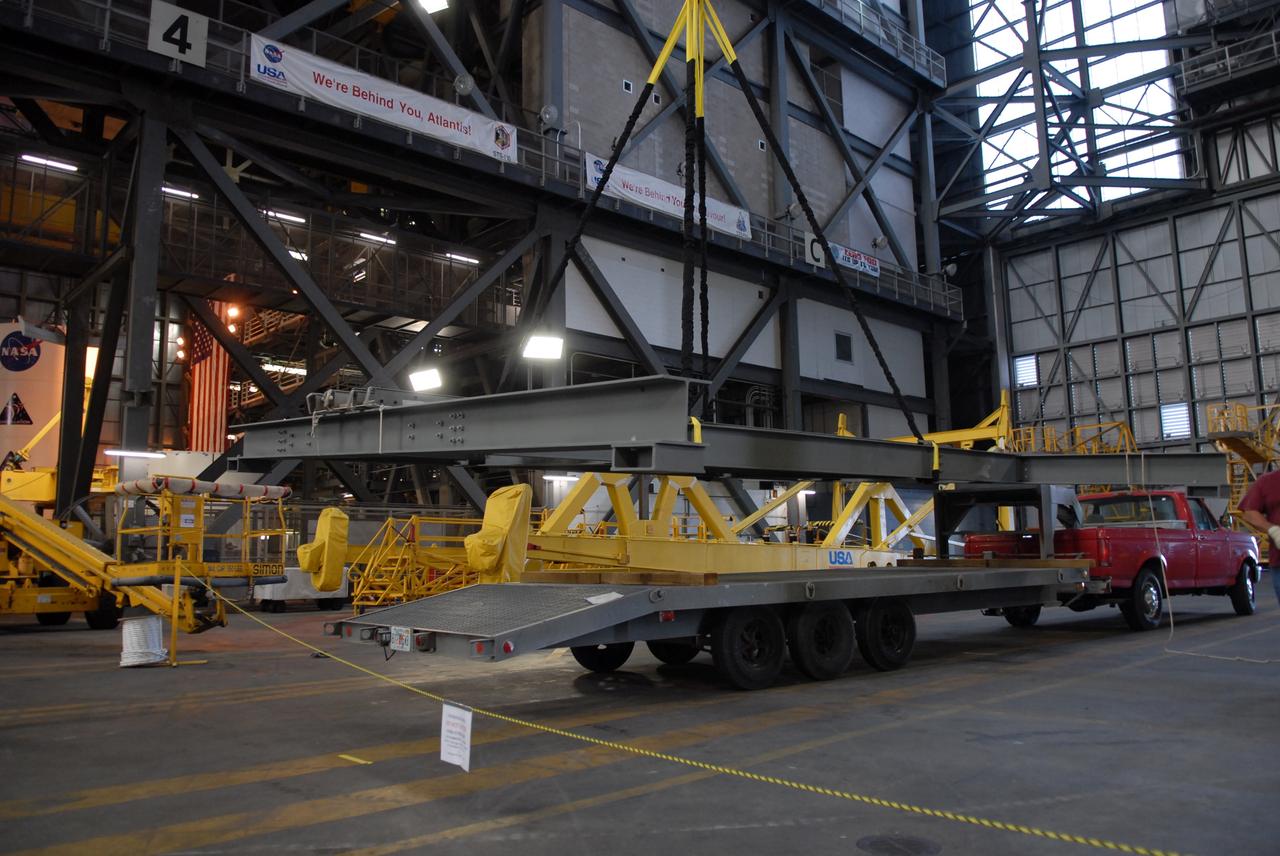 CAPE CANAVERAL, Fla. –    Framework is being lifted from a transporter to be installed on the 16th floor for modifications in the Vehicle Assembly Building's high bay 3 at NASA's Kennedy Space Center in Florida related to the Ares I-X. The refurbishment of the facility is for the Constellation Program's Ares vehicles. The Ares I and Ares V rockets will be 325 feet and 360 feet tall, respectively, considerably taller than the space shuttle atop its mobile launcher platform.    Photo credit: NASA/Troy Cryder