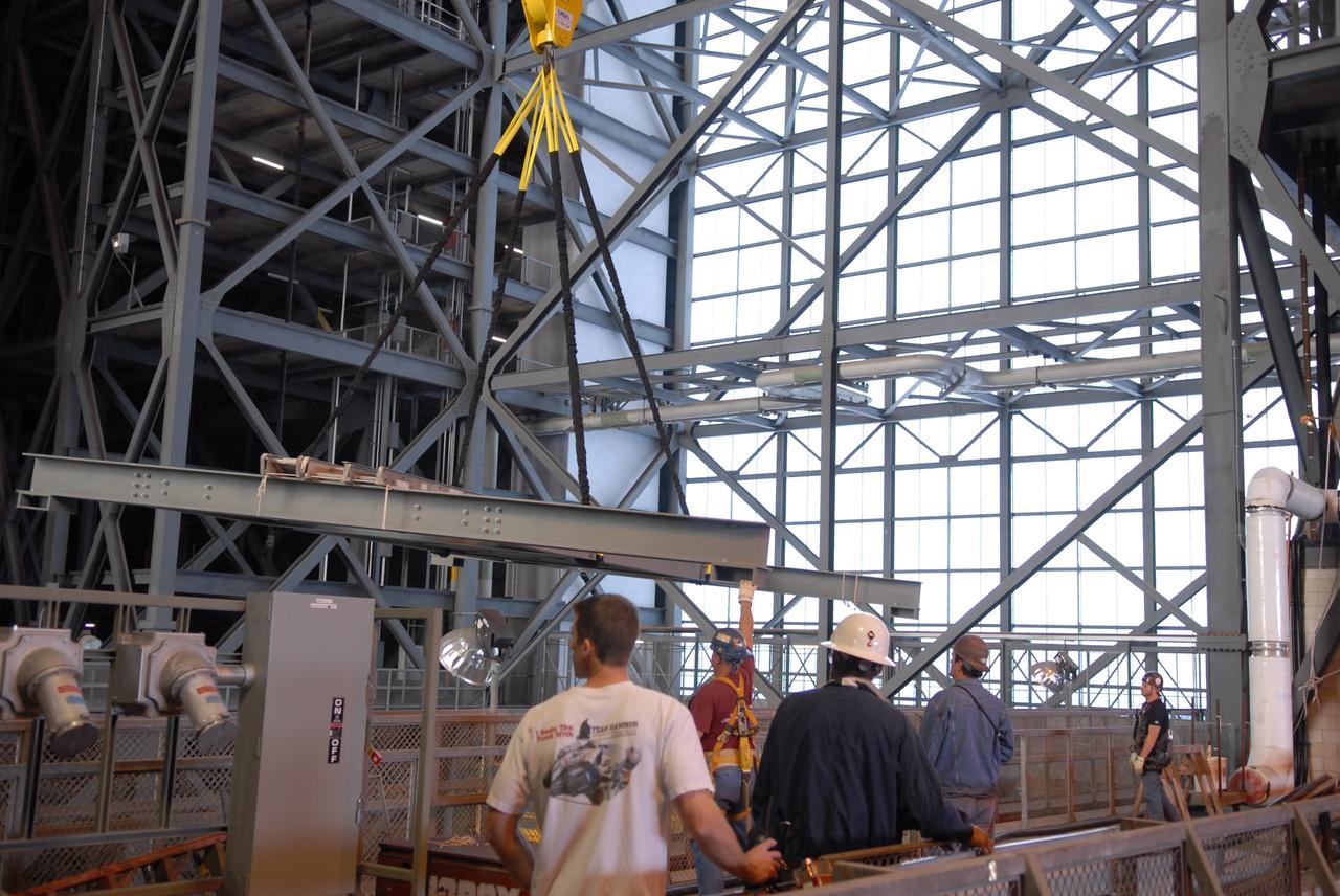 CAPE CANAVERAL, Fla. –   In the Vehicle Assembly Building's high bay 3 at NASA's Kennedy Space Center in Florida, framework is lifted to the 16th floor for modifications related to the Ares I-X. The refurbishment of the facility is for the Constellation Program's Ares vehicles.  The Ares I and Ares V rockets will be 325 feet and 360 feet tall, respectively, considerably taller than the space shuttle atop its mobile launcher platform.    Photo credit: NASA/Troy Cryder