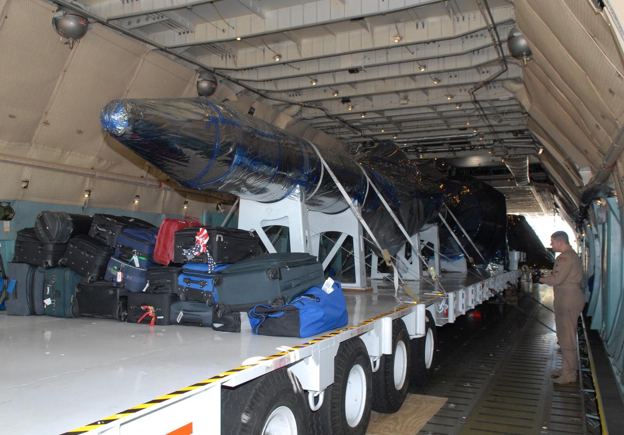 CAPE CANAVERAL, Fla. – Inside a C-5 aircraft, hardware that will be used in the launch of the Ares I-X rocket is being offloaded at the Shuttle Landing Facility at NASA's Kennedy Space Center in Florida. The hardware consists of a precisely machined, full-scale simulator crew module and launch abort system to form the tip of NASA's Ares I-X rocket. The launch of the 321-foot-tall, full-scale Ares I-X, targeted for July 2009, will be the first in a series of unpiloted rocket launches from Kennedy. When fully developed, the 16-foot diameter crew module will furnish living space and reentry protection for the astronauts, while their launch abort system will provide safe evacuation if a launch vehicle failure occurs. Photo credit: NASA/Jack Pfaller