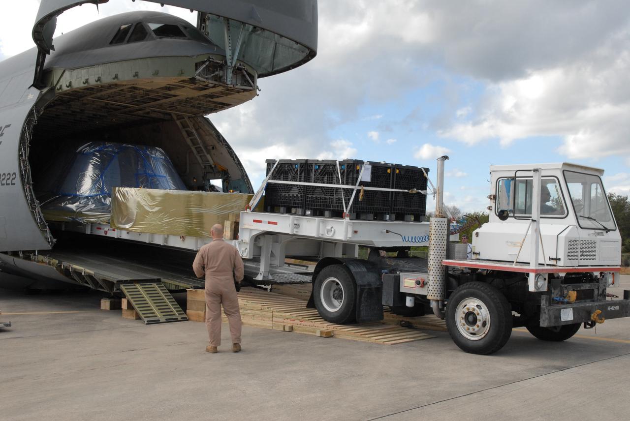 CAPE CANAVERAL, Fla. – At the Shuttle Landing Facility at NASA's Kennedy Space Center in Florida, hardware that will be used in the launch of the Ares I-X rocket is being offloaded from the C-5 aircraft. The hardware consists of a precisely machined, full-scale simulator crew module and launch abort system to form the tip of NASA's Ares I-X rocket. The launch of the 321-foot-tall, full-scale Ares I-X, targeted for July 2009, will be the first in a series of unpiloted rocket launches from Kennedy. When fully developed, the 16-foot diameter crew module will furnish living space and reentry protection for the astronauts, while their launch abort system will provide safe evacuation if a launch vehicle failure occurs.    Photo credit: NASA/Jack Pfaller