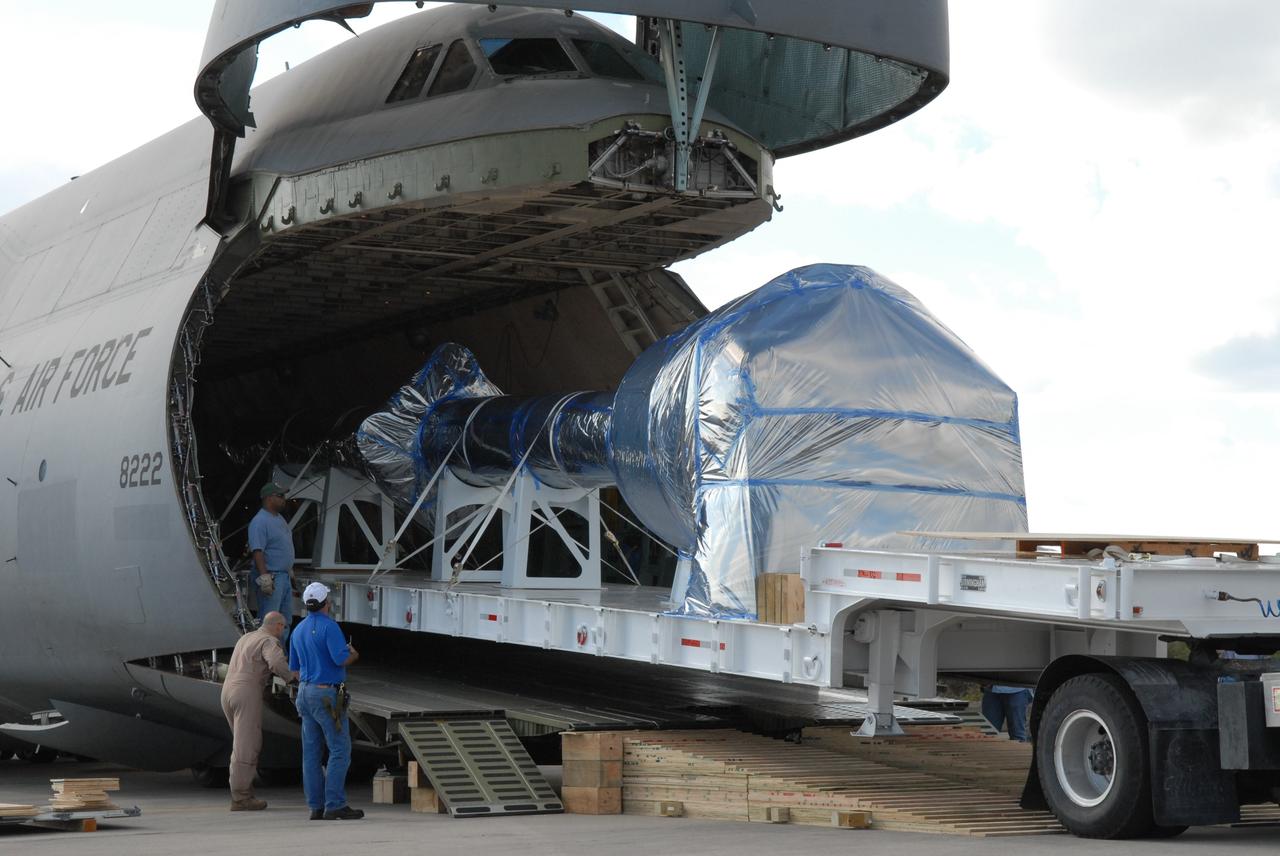 CAPE CANAVERAL, Fla. – At the Shuttle Landing Facility at NASA's Kennedy Space Center in Florida, hardware that will be used in the launch of the Ares I-X rocket is being offloaded from the C-5 aircraft. The hardware consists of a precisely machined, full-scale simulator crew module and launch abort system to form the tip of NASA's Ares I-X rocket. The launch of the 321-foot-tall, full-scale Ares I-X, targeted for July 2009, will be the first in a series of unpiloted rocket launches from Kennedy. When fully developed, the 16-foot diameter crew module will furnish living space and reentry protection for the astronauts, while their launch abort system will provide safe evacuation if a launch vehicle failure occurs.    Photo credit: NASA/Jack Pfaller