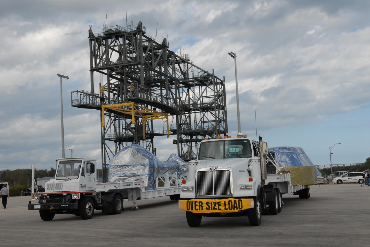 CAPE CANAVERAL, Fla. – At the Shuttle Landing Facility at NASA's Kennedy Space Center in Florida, trucks are ready to transport their cargo to the Vehicle Assembly Building's high bay 4. The cargo consists of a precisely machined, full-scale simulator crew module and launch abort system that will be used in the launch of NASA's Ares I-X rocket.  The launch of the 321-foot-tall, full-scale Ares I-X, targeted for July 2009, will be the first in a series of unpiloted rocket launches from Kennedy. When fully developed, the 16-foot diameter crew module will furnish living space and reentry protection for the astronauts, while their launch abort system will provide safe evacuation if a launch vehicle failure occurs.    Photo credit: NASA/Jack Pfaller