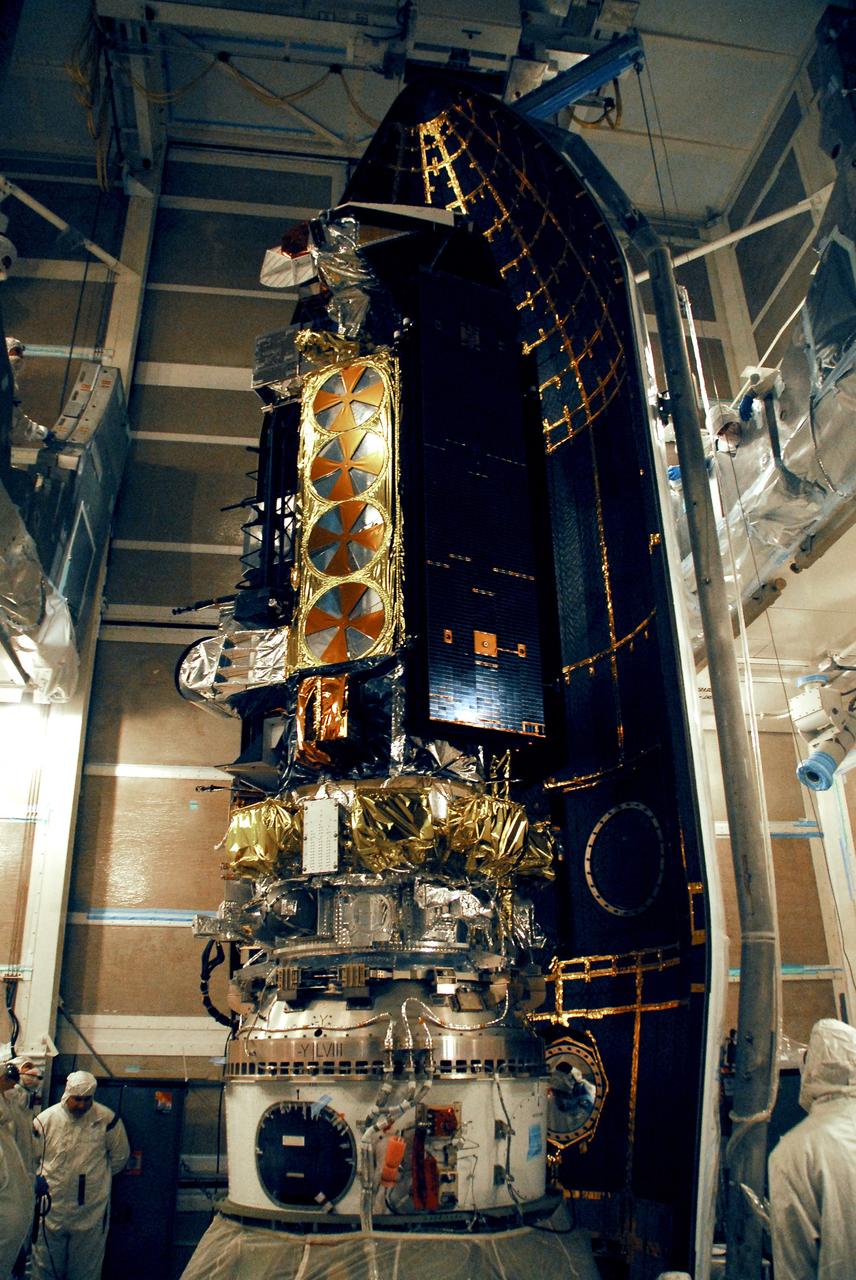 VANDENBERG AIR FORCE BASE, Calif. --  The first half of the fairing is moved into place around the NOAA-N Prime spacecraft in the launch service tower on Space Launch Complex 2 at Vandenberg Air Force Base in California.  The fairing is a molded structure that fits flush with the outside surface of the rocket and forms an aerodynamically smooth nose cone, protecting the spacecraft during launch and ascent. NOAA-N Prime is the latest polar-orbiting operational environmental weather satellite developed by NASA for the National Oceanic and Atmospheric Administration.  It is built by Lockheed Martin and similar to NOAA-N that was launched on May 20, 2005. Launch of NOAA-N Prime aboard a Delta II rocket is scheduled for Feb. 4.   Photo credit: NASA