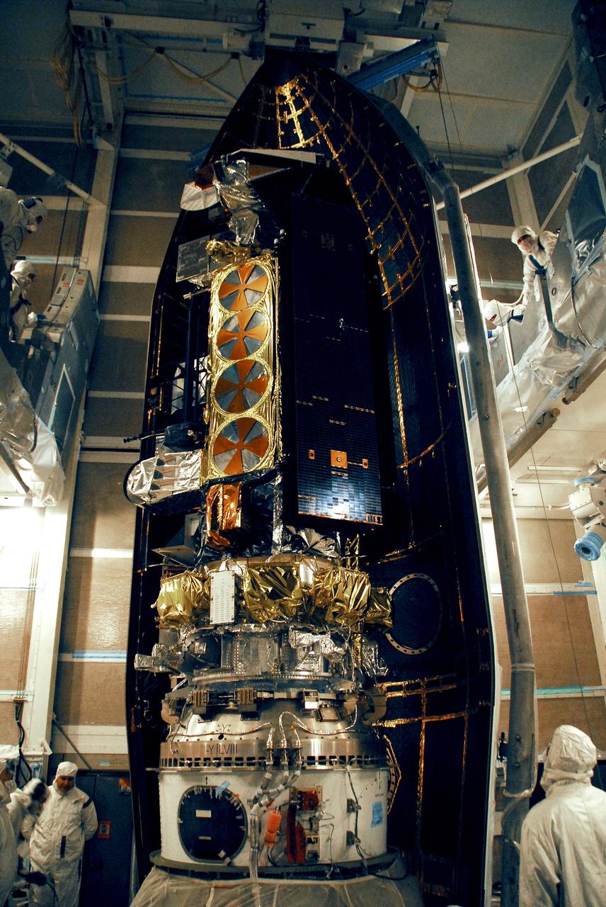 VANDENBERG AIR FORCE BASE, Calif. --  The first half of the fairing is moved into place around the NOAA-N Prime spacecraft in the launch service tower on Space Launch Complex 2 at Vandenberg Air Force Base in California.  The fairing is a molded structure that fits flush with the outside surface of the rocket and forms an aerodynamically smooth nose cone, protecting the spacecraft during launch and ascent. NOAA-N Prime is the latest polar-orbiting operational environmental weather satellite developed by NASA for the National Oceanic and Atmospheric Administration.  It is built by Lockheed Martin and similar to NOAA-N that was launched on May 20, 2005. Launch of NOAA-N Prime aboard a Delta II rocket is scheduled for Feb. 4.   Photo credit: NASA