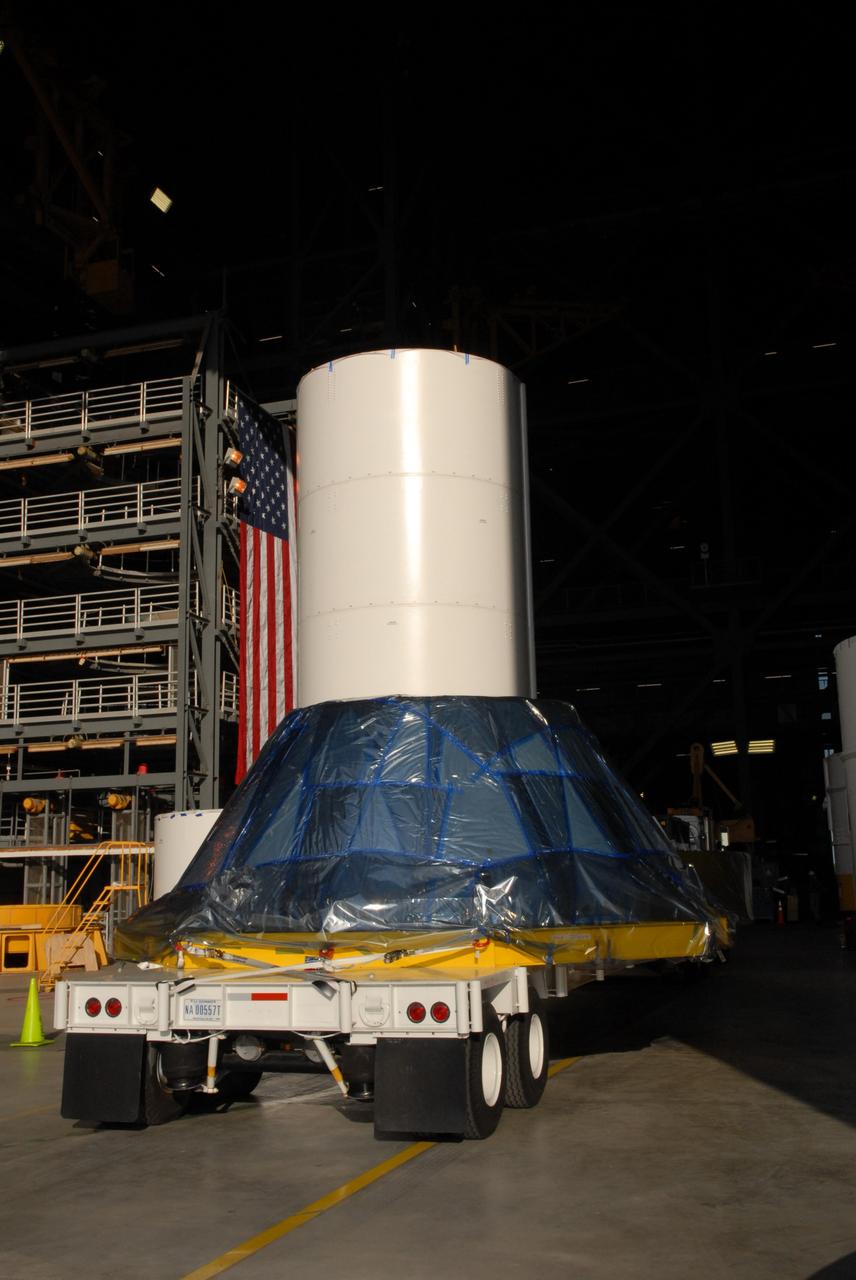 CAPE CANAVERAL, Fla. – The simulator crew module for NASA's Ares I-X rocket is moved into the Vehicle Assembly Building's high bay 4 at NASA's Kennedy Space Center in Florida. The precisely machined, full-scale simulator crew module is part of the hardware that will be used in the launch of the rocket. Also arriving is a launch abort system that, with the module, will form the tip of the rocket. Ares I-X is the test flight for the Ares I. The I-X flight will provide NASA an early opportunity to test and prove hardware, facilities and ground operations associated with Ares I. The launch of the 321-foot-tall, full-scale Ares I-X, targeted for July 2009, will be the first in a series of unpiloted rocket launches from Kennedy. When fully developed, the 16-foot diameter crew module will furnish living space and reentry protection for the astronauts, while their launch abort system will provide safe evacuation if a launch vehicle failure occurs. Photo credit: NASA/Jack Pfaller