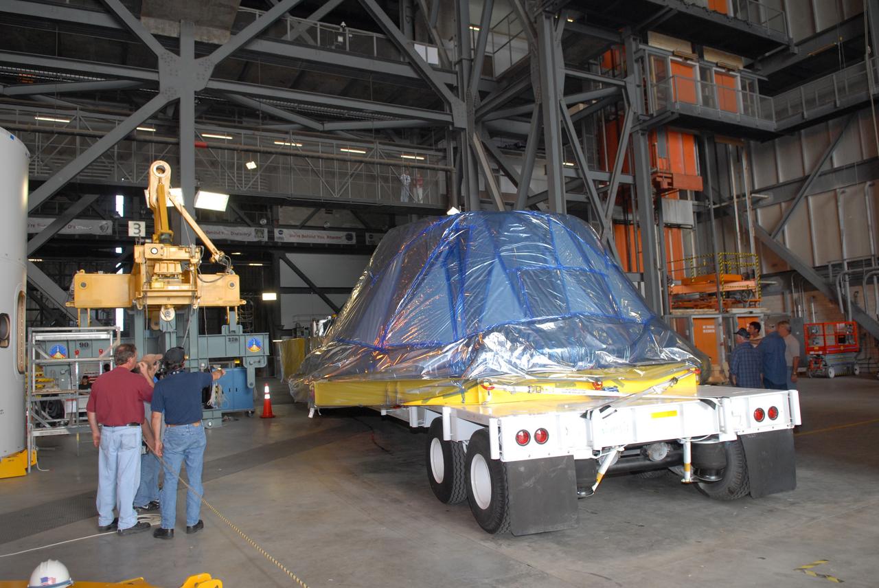 CAPE CANAVERAL, Fla. – The simulator crew module for NASA's Ares I-X rocket is moved into the Vehicle Assembly Building's high bay 4 at NASA's Kennedy Space Center in Florida. The precisely machined, full-scale simulator crew module is part of the hardware that will be used in the launch of the rocket. Also arriving is a launch abort system that, with the module, will form the tip of the rocket. Ares I-X is the test flight for the Ares I. The I-X flight will provide NASA an early opportunity to test and prove hardware, facilities and ground operations associated with Ares I. The launch of the 321-foot-tall, full-scale Ares I-X, targeted for July 2009, will be the first in a series of unpiloted rocket launches from Kennedy. When fully developed, the 16-foot diameter crew module will furnish living space and reentry protection for the astronauts, while their launch abort system will provide safe evacuation if a launch vehicle failure occurs. Photo credit: NASA/Jack Pfaller