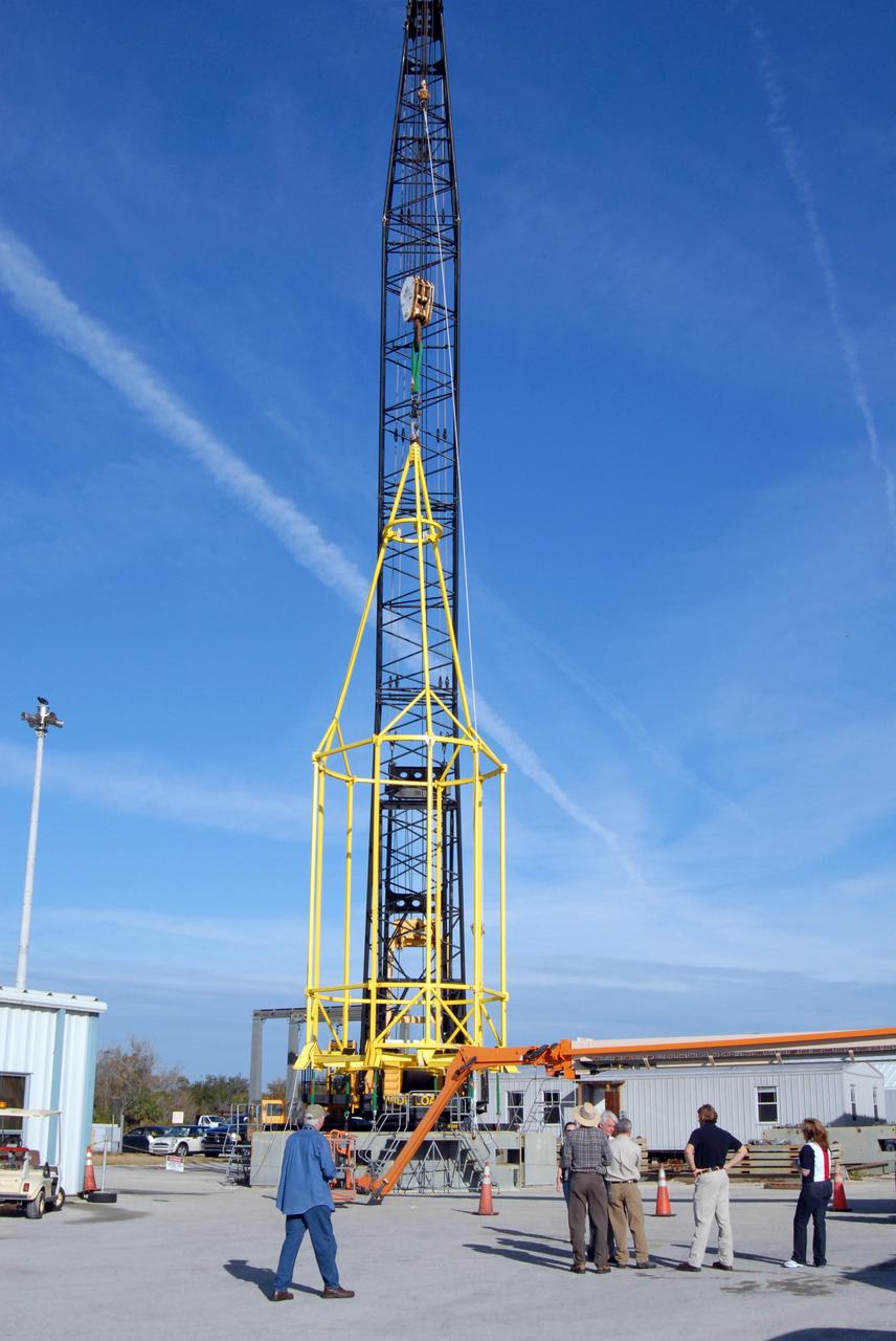 CAPE CANAVERAL, Fla. –  The lifting fixture nicknamed the "Birdcage" is lifted by a crane to test the load capability.  The Birdcage will be used to lift the Crew Module, or CM, and Launch Abort System, or LAS, assembly for the Ares I-X rocket and to stack and de-stack the assembly from the Service Module/Spacecraft Adapter assembly.  It will also have the ability to lift and to stack and de-stack Stack-5  (all of the above components) from the Ares I-X in the Vehicle Assembly Building at NASA's Kennedy Space Center in Florida.  Ares I-X is the test flight for the Ares I.   The I-X flight will provide NASA an early opportunity to test and prove hardware, facilities and ground operations associated with Ares I. The launch of the 321-foot-tall, full-scale Ares I-X, targeted for July 2009, will be the first in a series of unpiloted rocket launches from Kennedy. When fully developed, the 16-foot diameter crew module will furnish living space and reentry protection for the astronauts, while their launch abort system will provide safe evacuation if a launch vehicle failure occurs.   Photo credit: NASA/Jack Pfaller
