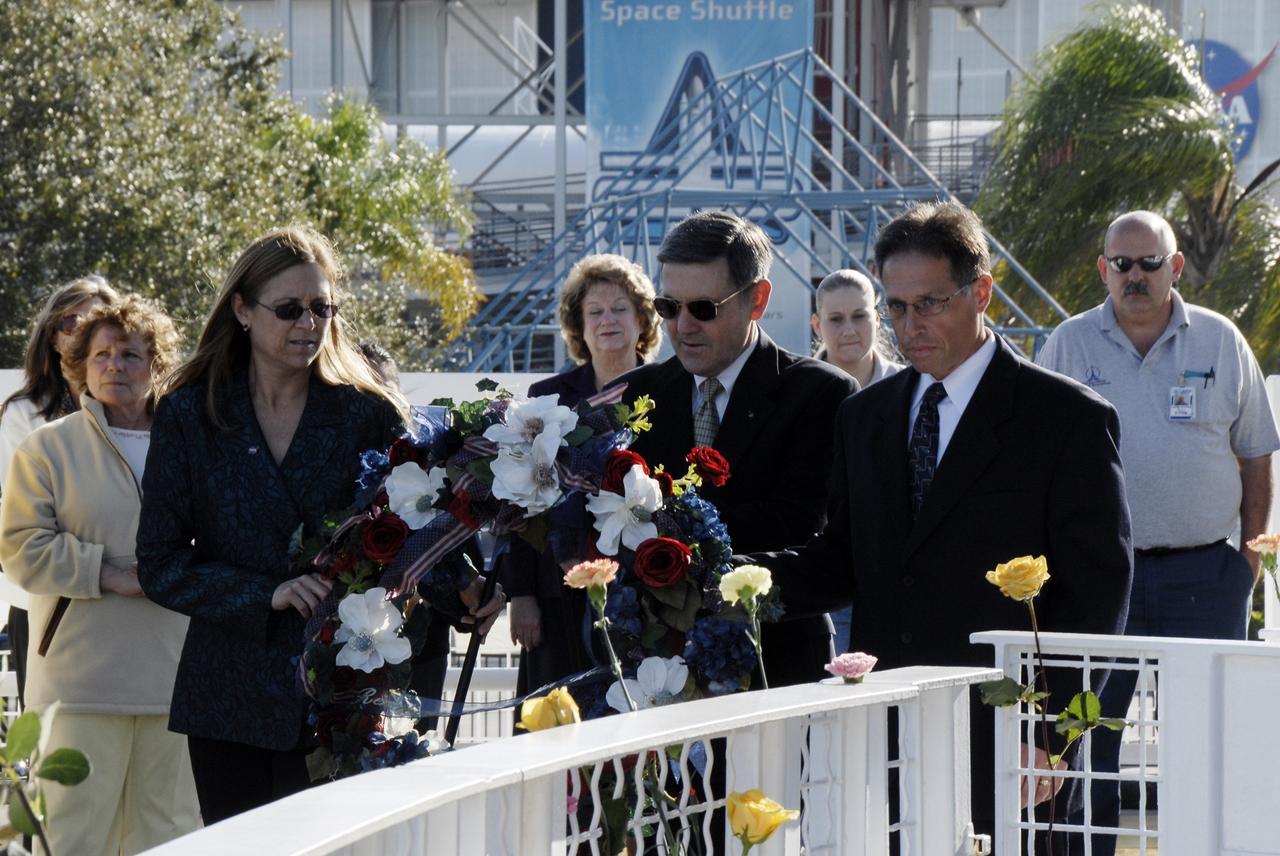 CAPE CANAVERAL, Fla. – At the Kennedy Space Center Visitor Complex, Center Director Bob Cabana (center) and Deputy Director Janet Petro take part in a wreath-laying ceremony paying tribute to the crews of Apollo 1 and space shuttles Challenger and Columbia, as well as other NASA colleagues who lost their lives while furthering the cause of exploration and discovery, during NASA's Day of Remembrance observance. At right is United Space Alliance Vice President of Launch and Recovery Systems and Florida Site Executive Mark Nappi. The public was invited to the wreath-laying ceremony in front of the Space Mirror Memorial. Photo credit: NASA/Kim Shiflett