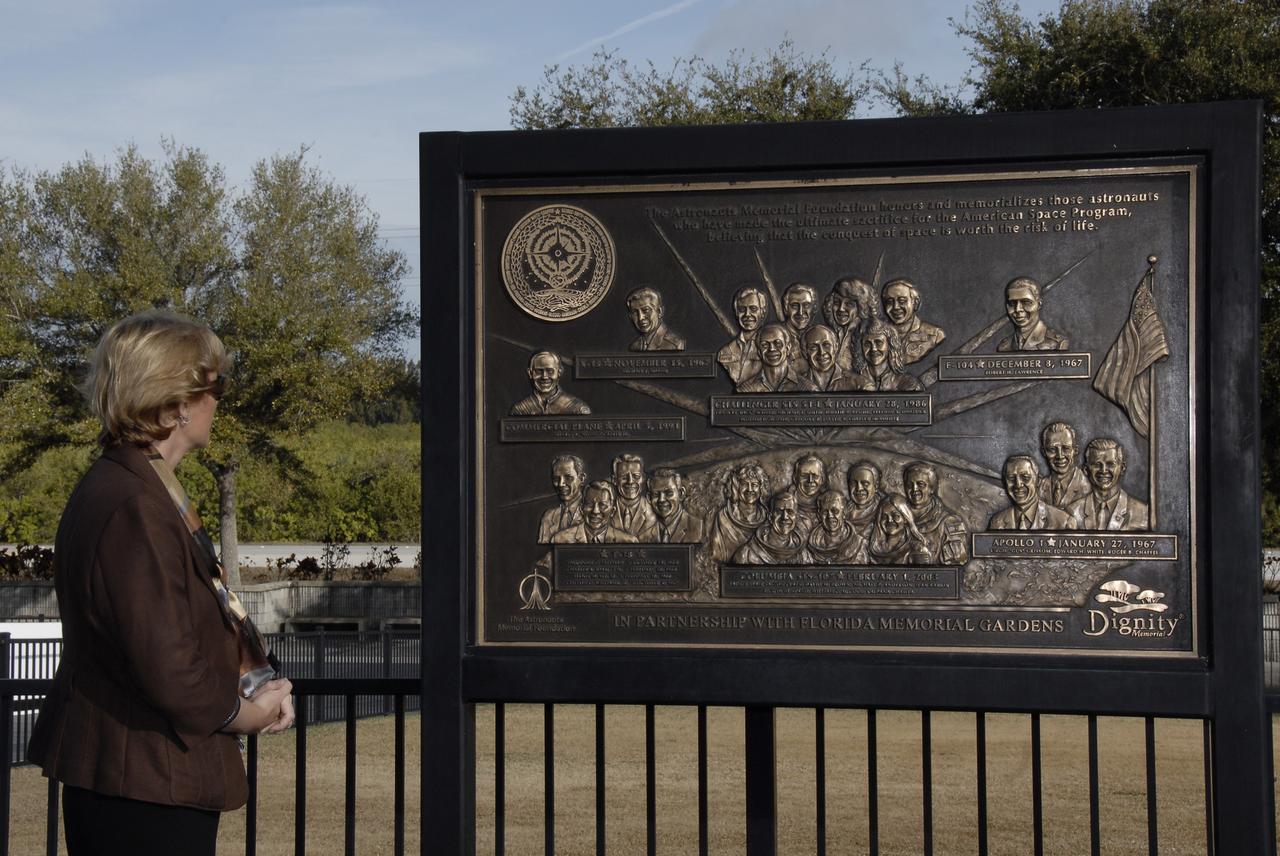 CAPE CANAVERAL, Fla. –   Near the Space Mirror Memorial at NASA's Kennedy Space Center Visitor Complex, a large plaque commemorates the crews of Apollo 1 and space shuttles Challenger and Columbia who lost their lives while furthering the cause of exploration and discovery. At left is Tara Gillam, manager of the Office of Diversity and Equal Opportunity at Kennedy.  Jan. 29 is NASA's Day of Remembrance observance and included a wreath-laying ceremony in front of the Space Mirror Memorial. Photo credit: NASA/Kim Shiflett