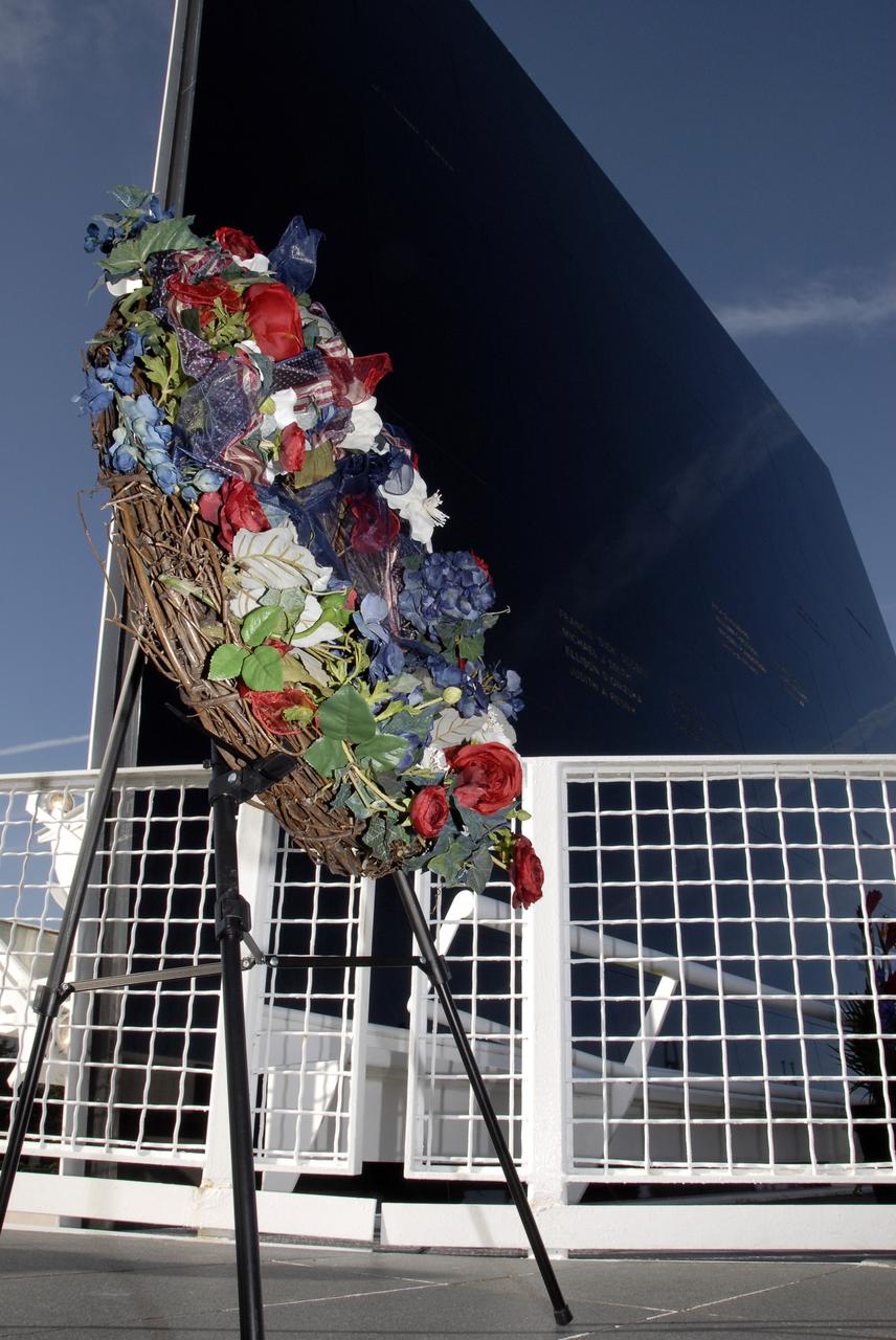 CAPE CANAVERAL, Fla. –  Near the Space Mirror Memorial at the Kennedy Space Center Visitor Complex, a floral wreath has been placed during NASA's Day of Remembrance observance paying tribute to the crews of Apollo 1 and space shuttles Challenger and Columbia, as well as other NASA colleagues who lost their lives while furthering the cause of exploration and discovery.  Center Director Bob Cabana presided over the ceremony, which was open to the public.  Photo credit: NASA/Kim Shiflett