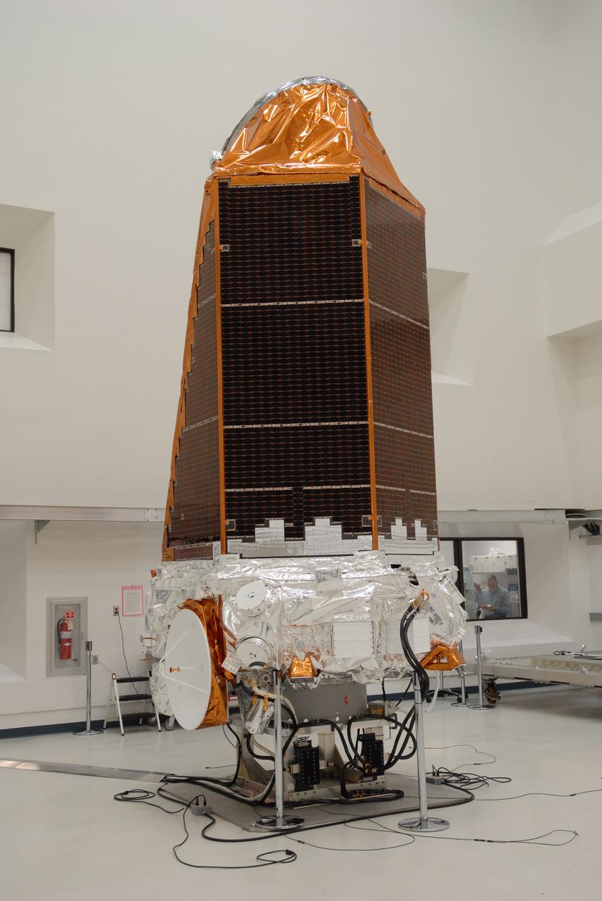 CAPE CANAVERAL, Fla. – NASA's Kepler spacecraft, that will be launched in March aboard a United Launch Alliance Delta II rocket, is ready for the media opportunity Jan. 30. Visible are the solar arrays on top and the high-gain antenna at lower left. The event, being held at the Astrotech Space Operations facility in Titusville, Fla., will provide media representatives an opportunity to photograph the space telescope and to interview project officials from NASA and Ball Aerospace, builder of the spacecraft. Kepler is designed to survey more that 100,000 stars in our galaxy to determine the number of sun-like stars that have Earth-size and larger planets, including those that lie in a star's "habitable zone," a region where liquid water, and perhaps life, could exist. If these Earth-size worlds do exist around stars like our sun, Kepler is expected to be the first to find them and the first to measure how common they are. The liftoff of Kepler aboard a Delta II rocket is currently planned for 10:48 p.m. EST March 5 from Space Launch Complex 17 on Cape Canaveral Air Force Station. Photo credit: NASA/Troy Cryder