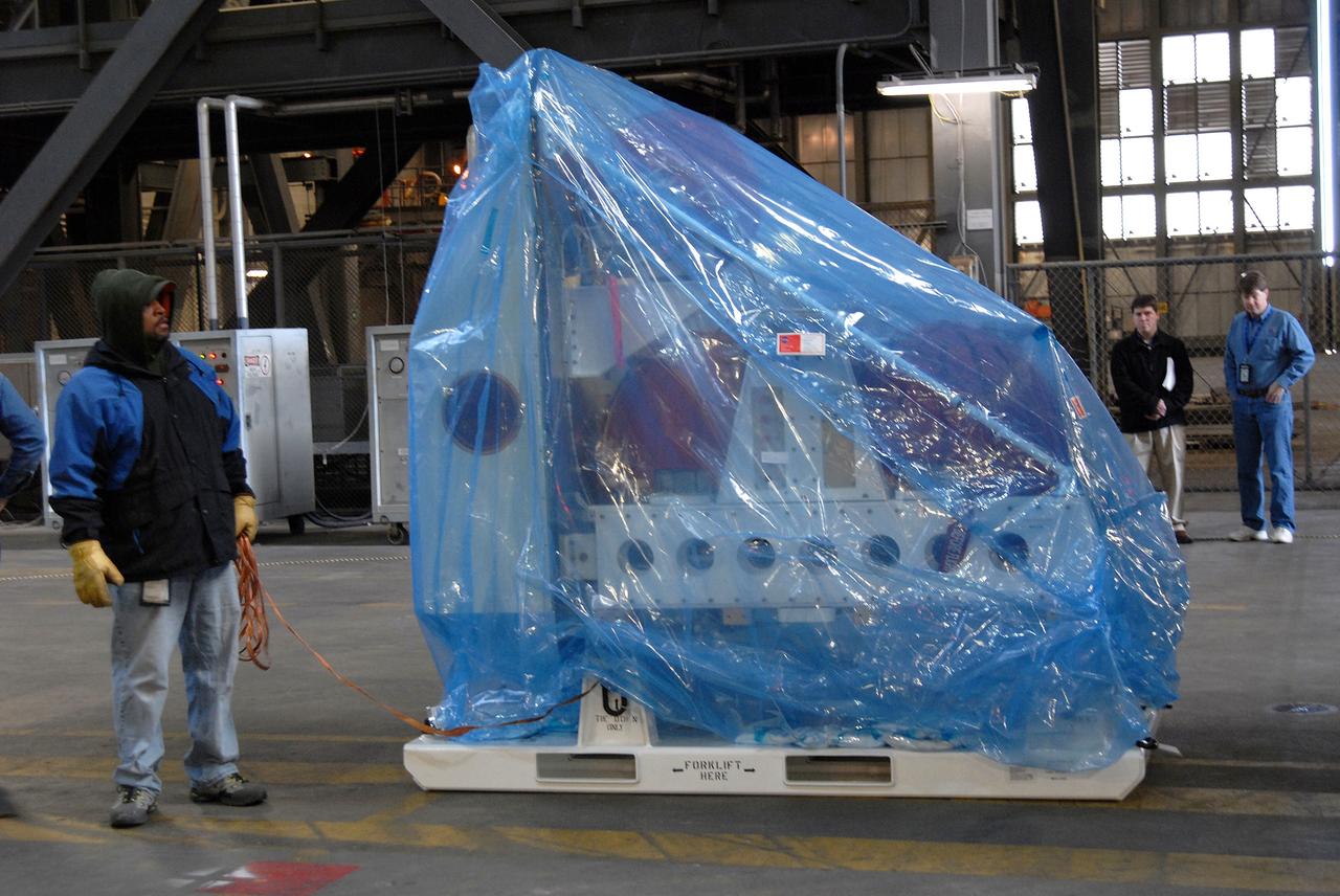 CAPE CANAVERAL, Fla. – The Ares I-X roll control system module has been placed on the floor of the Vehicle Assembly Building at NASA's Kennedy Space Center in Florida after its arrival. The system is designed to perform a 90-degree roll after the rocket clears the launch tower, preventing a roll during flight and maintaining the orientation of the rocket until separation of the upper and first stages. Part of the upper stage simulator, the system module is composed to two modules and four thrusters. The system module will return to earth and splash down; it will not be recovered. Ares I-X is the test vehicle for the Ares I, which is part of the Constellation Program to return men to the moon and beyond. Ares I is the essential core of a safe, reliable, cost-effective space transportation system that eventually will carry crewed missions back to the moon, on to Mars and out into the solar system. Ares I-X is targeted for launch in July 2009. Photo credit: NASA/Jack Pfaller