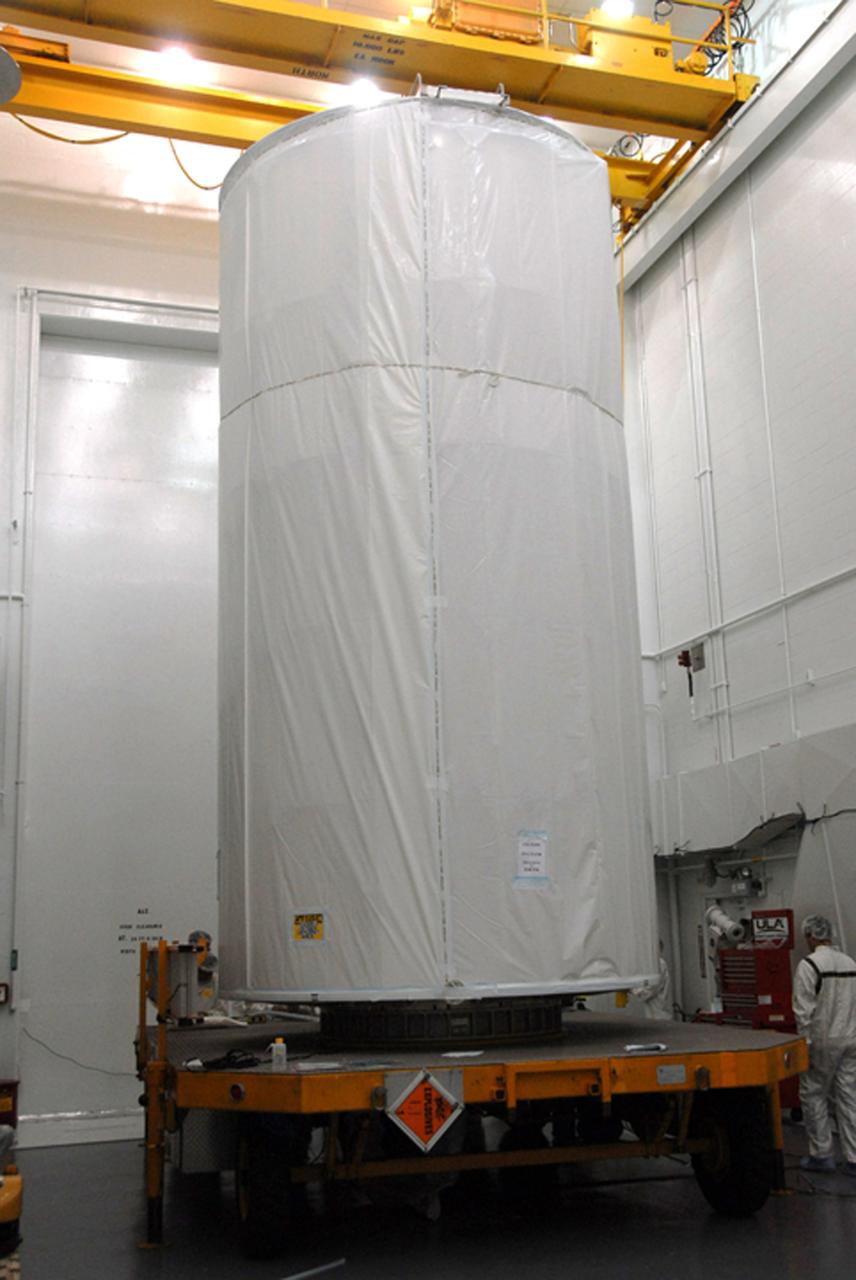 VANDENBERG AIR FORCE BASE, Calif. --  In Bldg. 1610 at Vandenberg Air Force Base in California, the covered NOAA-N Prime spacecraft is lowered onto a transporter.  NOAA-N Prime is the latest polar-orbiting operational environmental weather satellite developed by NASA for the National Oceanic and Atmospheric Administration.  The satellite is scheduled to launch Feb. 4 aboard a Delta II rocket from Vandenberg Air Force Base. Photo credit: NASA/ Daniel Liberotti, VAFB