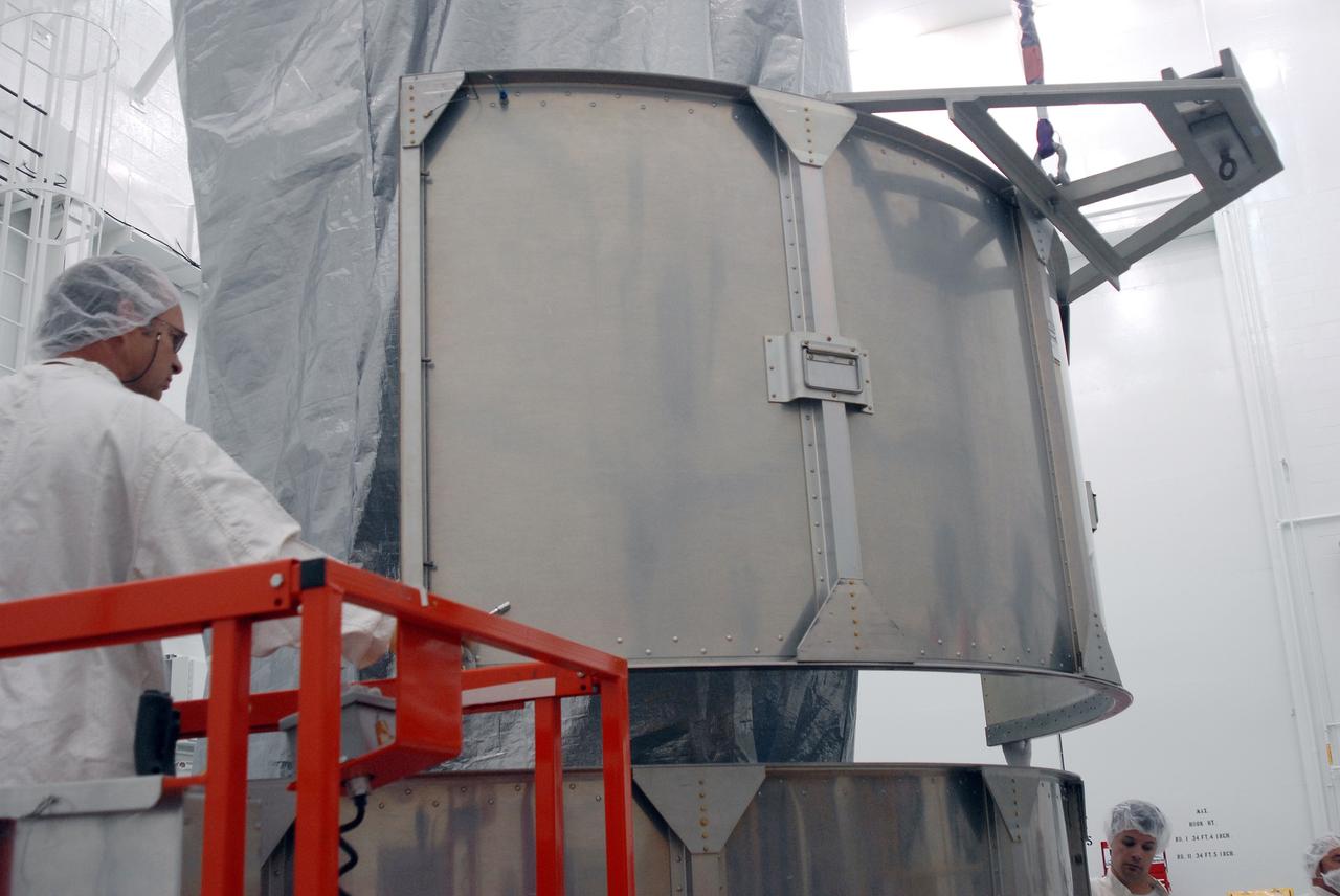 VANDENBERG AIR FORCE BASE, Calif. --  In Bldg. 1610 at Vandenberg Air Force Base in California, a second-row segment of a transportation canister is put in place for installation around the NOAA-N Prime spacecraft. NOAA-N Prime is the latest polar-orbiting operational environmental weather satellite developed by NASA for the National Oceanic and Atmospheric Administration.  The satellite is scheduled to launch Feb. 4 aboard a Delta II rocket from Vandenberg Air Force Base. Photo credit: NASA/ Daniel Liberotti, VAFB