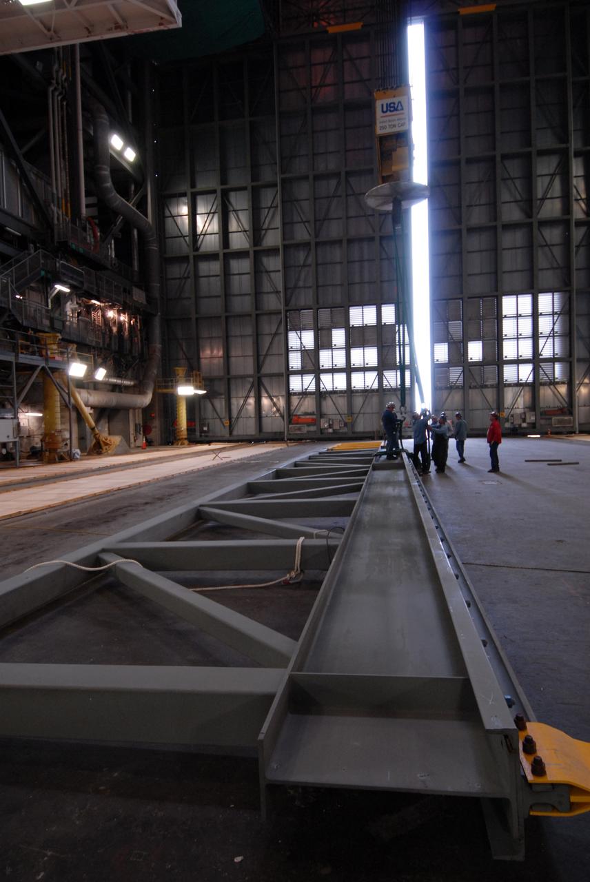 CAPE CANAVERAL, Fla. – In the Vehicle Assembly Building at NASA's Kennedy Space Center in Florida, an upper rail removed from high bay 3 rests on the floor. The removal is part of the modifications for the Constellation Program's Ares vehicles. The Ares I and Ares V rockets will be 325 feet and 360 feet tall, respectively, considerably taller than the space shuttle atop its mobile launcher platform.   Photo credit: NASA/Jack Pfaller