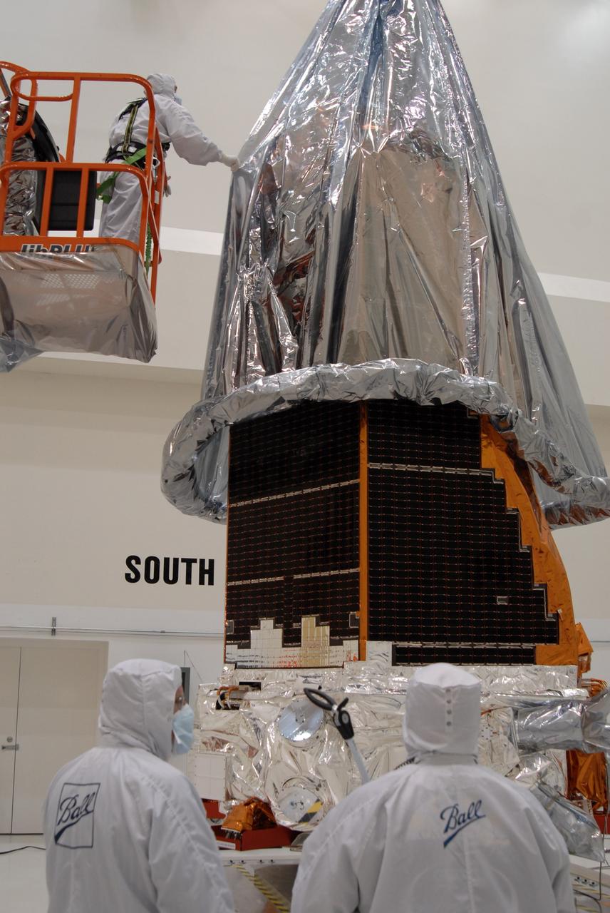 CAPE CANAVERAL, Fla. – At the Astrotech payload processing facility, the protective cover is lowered over NASA's Kepler spacecraft. When covered, Kepler will be moved to the Hazardous Processing Facility for fueling. Kepler is designed to survey more than 100,000 stars in our galaxy to determine the number of sun-like stars that have Earth-size and larger planets, including those that lie in a star's "habitable zone," a region where liquid water, and perhaps life, could exist. If these Earth-size worlds do exist around stars like our sun, Kepler is expected to be the first to find them and the first to measure how common they are. The liftoff of Kepler aboard a Delta II rocket is currently planned for 10:48 p.m. EST March 5 from Space Launch Complex 17 on Cape Canaveral Air Force Station. Photo credit: NASA/Jack Pfaller
